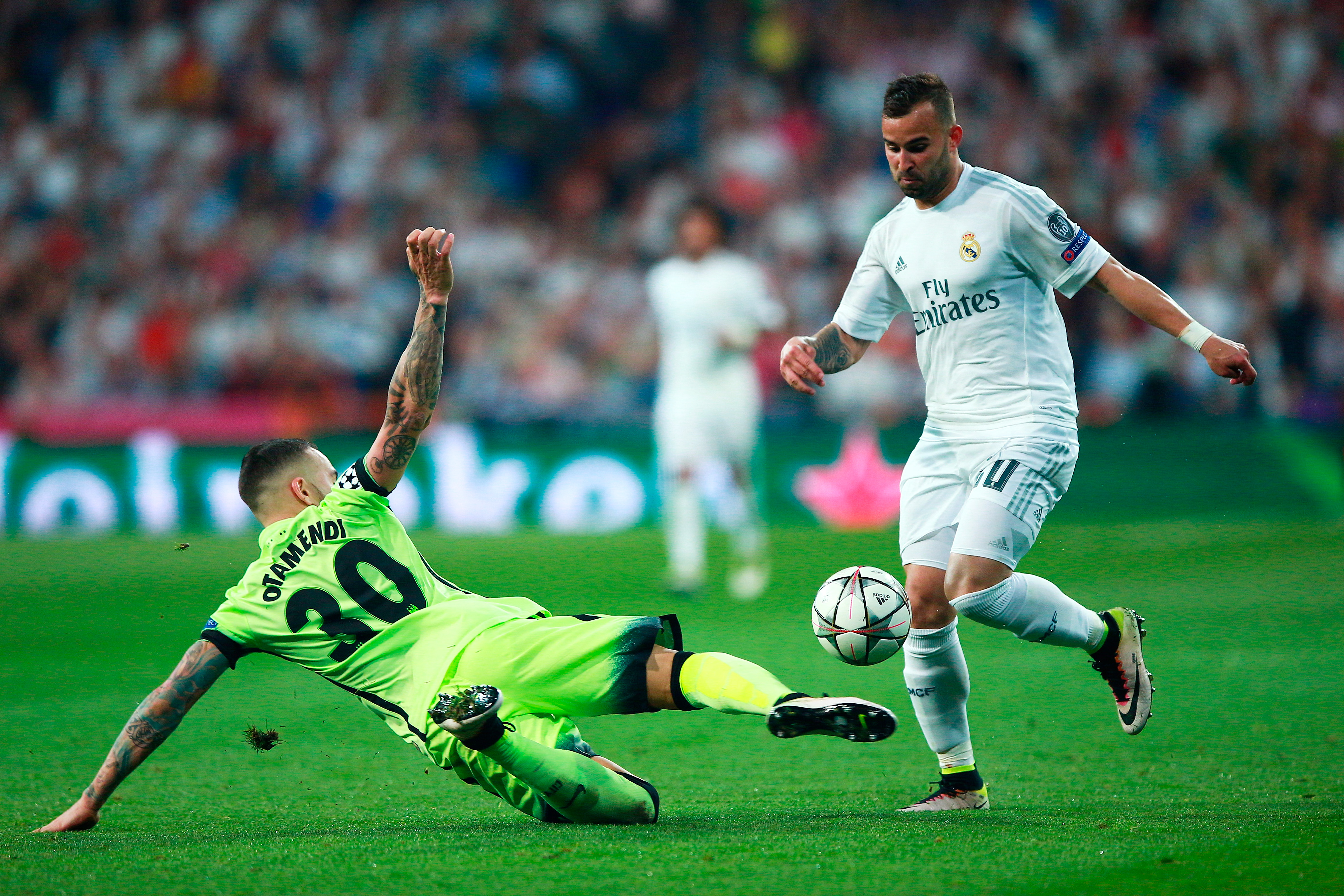 MADRID, SPAIN - MAY 04: Nicolas Otamendi of Manchester City makes a tackle on Jese of Real Madrid  during the UEFA Champions League semi final, second leg match between Real Madrid and Manchester City FC at Estadio Santiago Bernabeu on May 4, 2016 in Madrid, Spain.  (Photo by Gonzalo Arroyo Moreno/Getty Images)