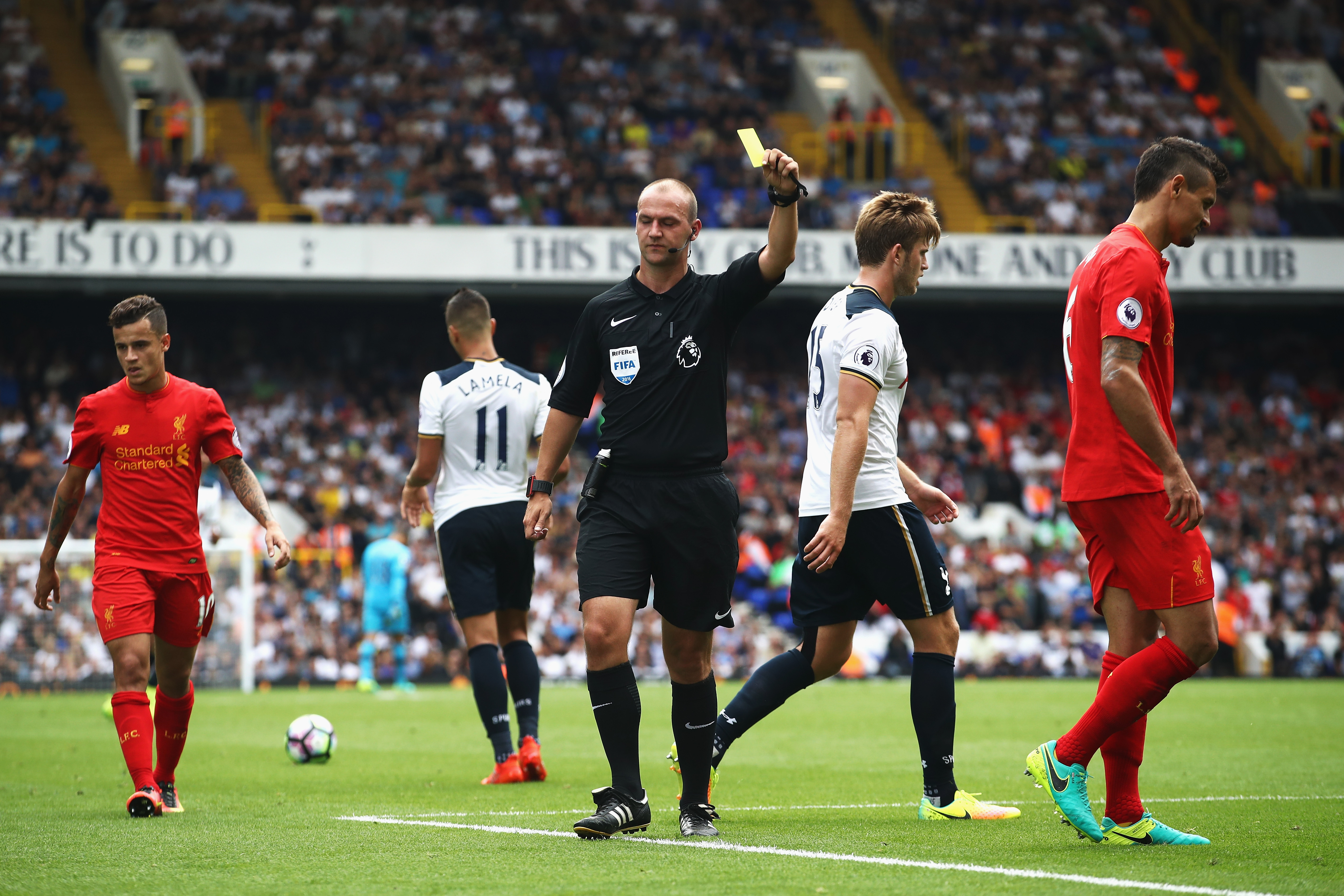 LONDON, ENGLAND - AUGUST 27: Referee Booby Madley pulls a yellow card out of his pocket during the Premier League match between Tottenham Hotspur and Liverpool at White Hart Lane on August 27, 2016 in London, England.  (Photo by Julian Finney/Getty Images)