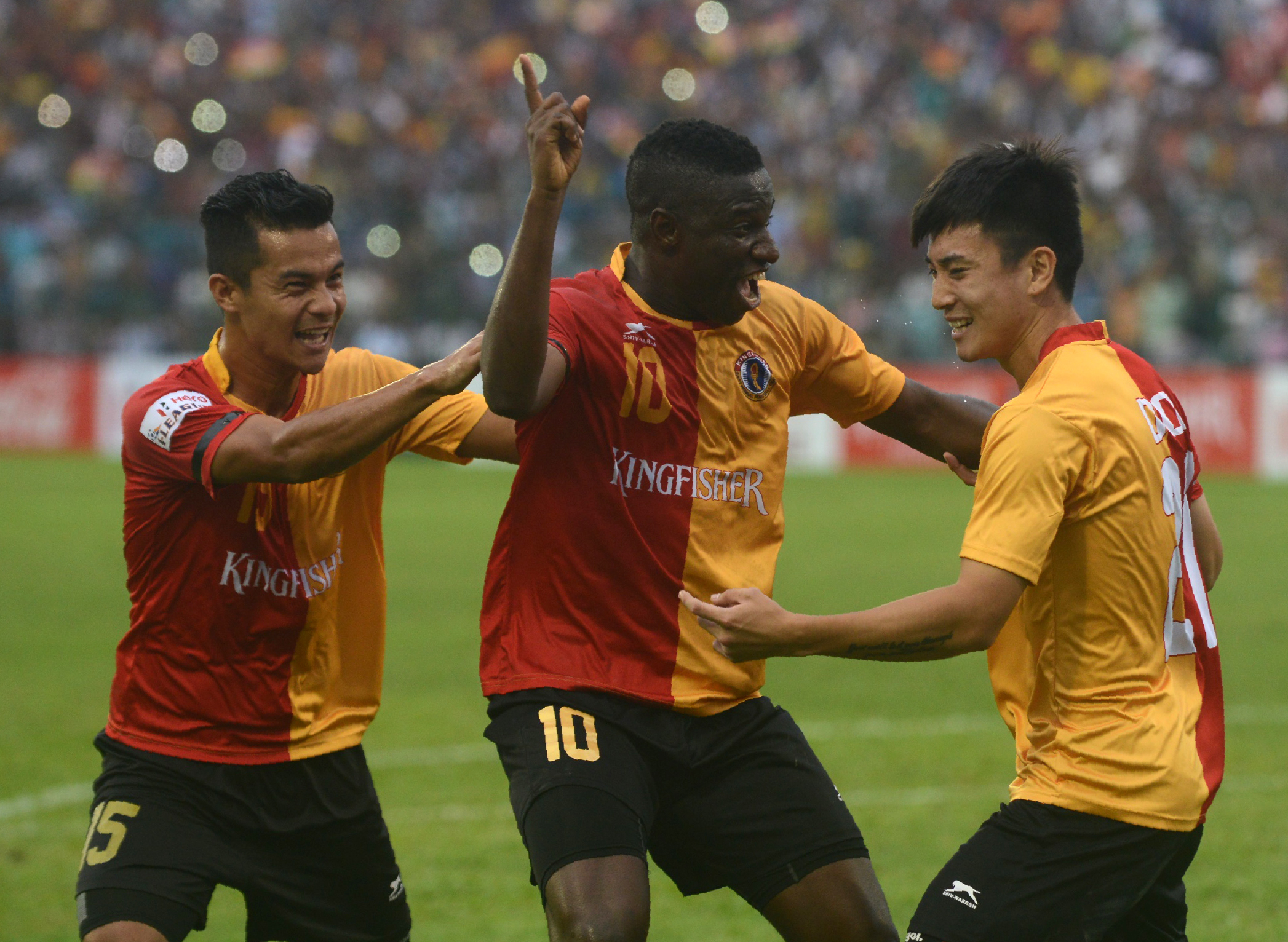 East Bengal's Do Dong(R),Ranti Martins(C) and Sanju Pradhan(L)celebrate after Do Dong scored during an I-League football match at The Kanchenjungha Stadium in Siliguri on April 2, 2016.
East Bengal won the match 2-1. / AFP / DIPTENDU DUTTA        (Photo credit should read DIPTENDU DUTTA/AFP/Getty Images)