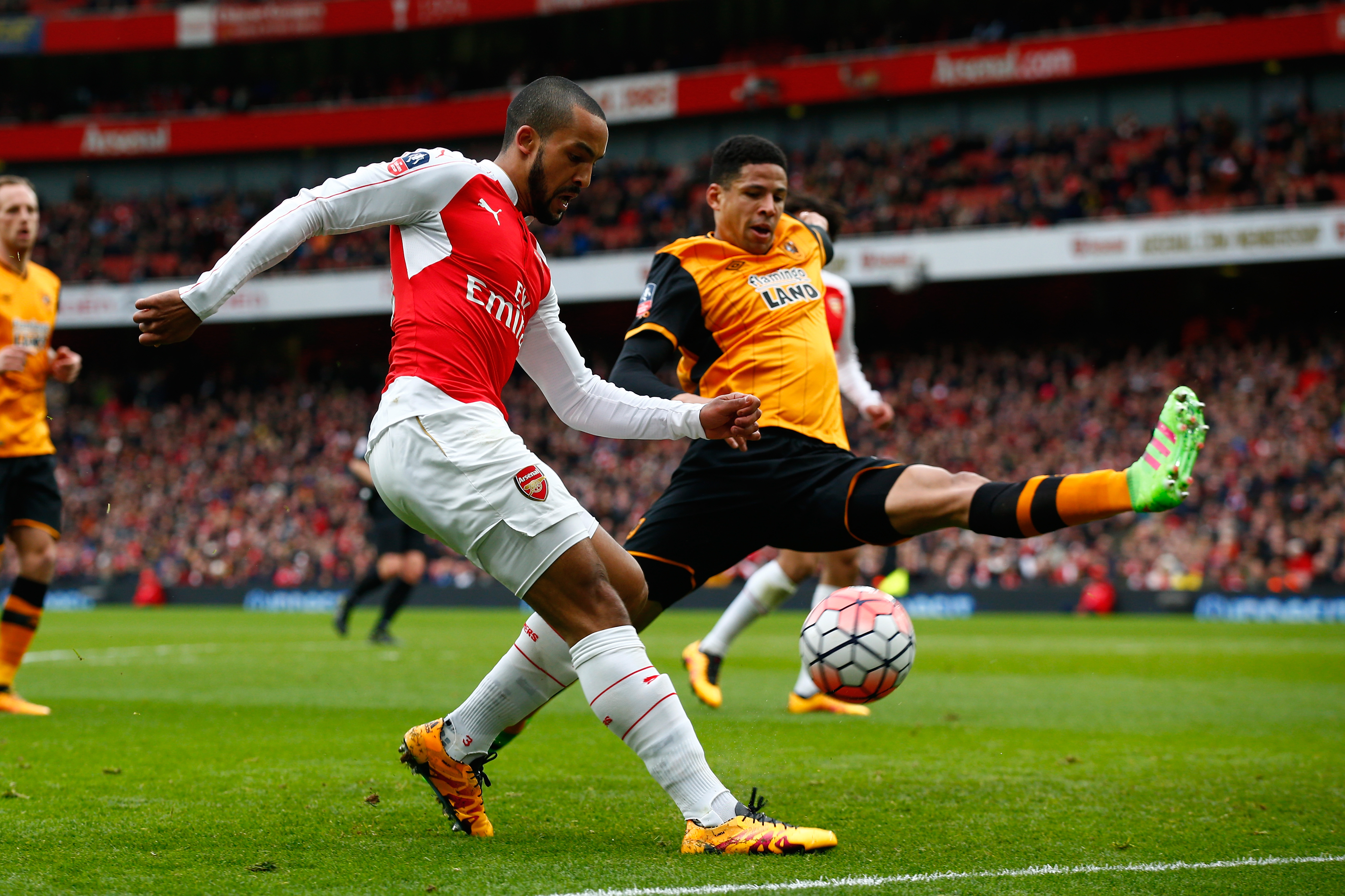 LONDON, ENGLAND - FEBRUARY 20: Theo Walcott of Arsenal and Curtis Davies of Hull City compete for the ball during the Emirates FA Cup fifth round match between Arsenal and Hull City at the Emirates Stadium on February 20, 2016 in London, England.  (Photo by Clive Rose/Getty Images)