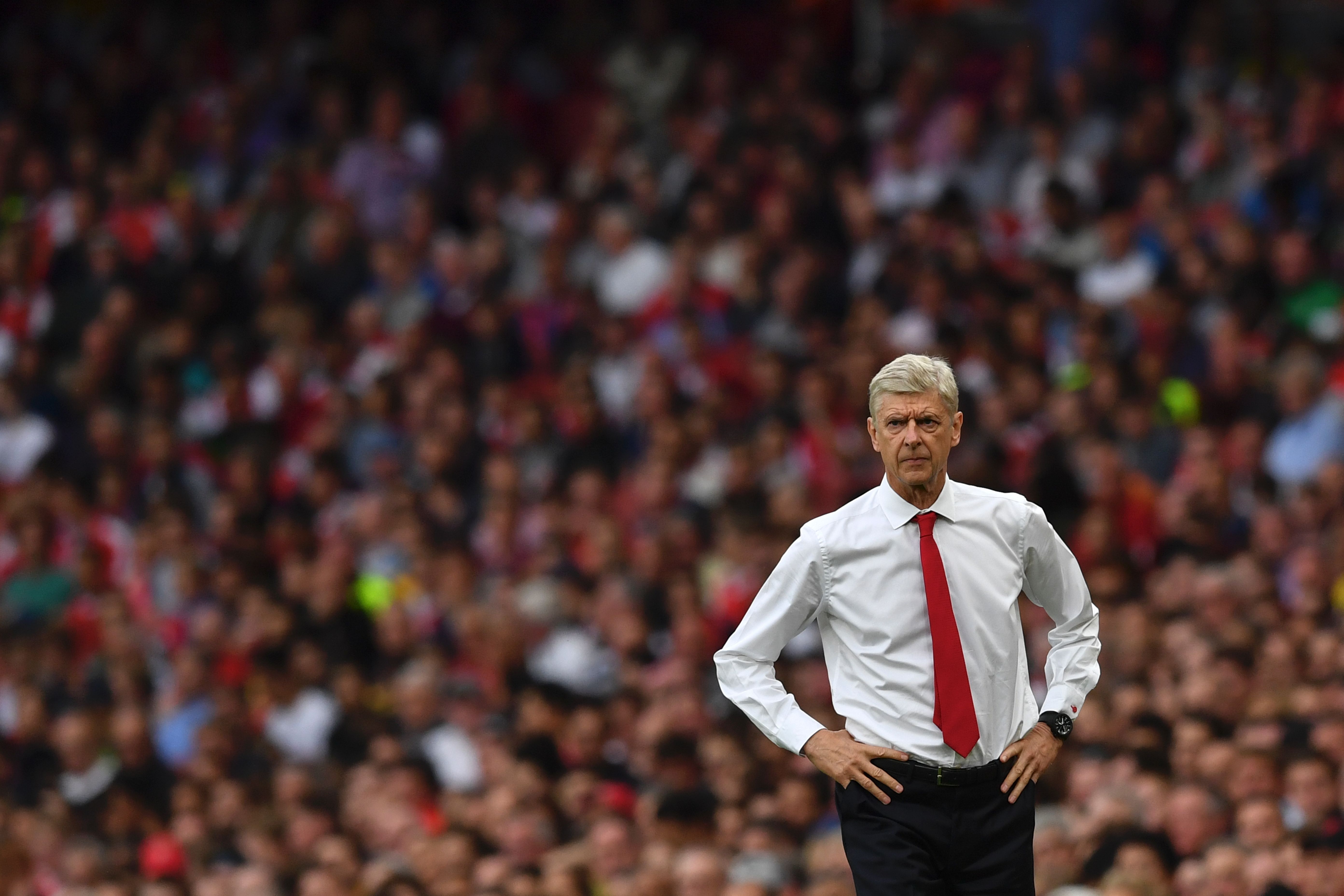 Arsenal's French manager Arsene Wenger looks on from the touchline during the English Premier League football match between Arsenal and Chelsea at the Emirates Stadium in London on September 24, 2016.  / AFP / Ben STANSALL / RESTRICTED TO EDITORIAL USE. No use with unauthorized audio, video, data, fixture lists, club/league logos or 'live' services. Online in-match use limited to 75 images, no video emulation. No use in betting, games or single club/league/player publications.  /         (Photo credit should read BEN STANSALL/AFP/Getty Images)