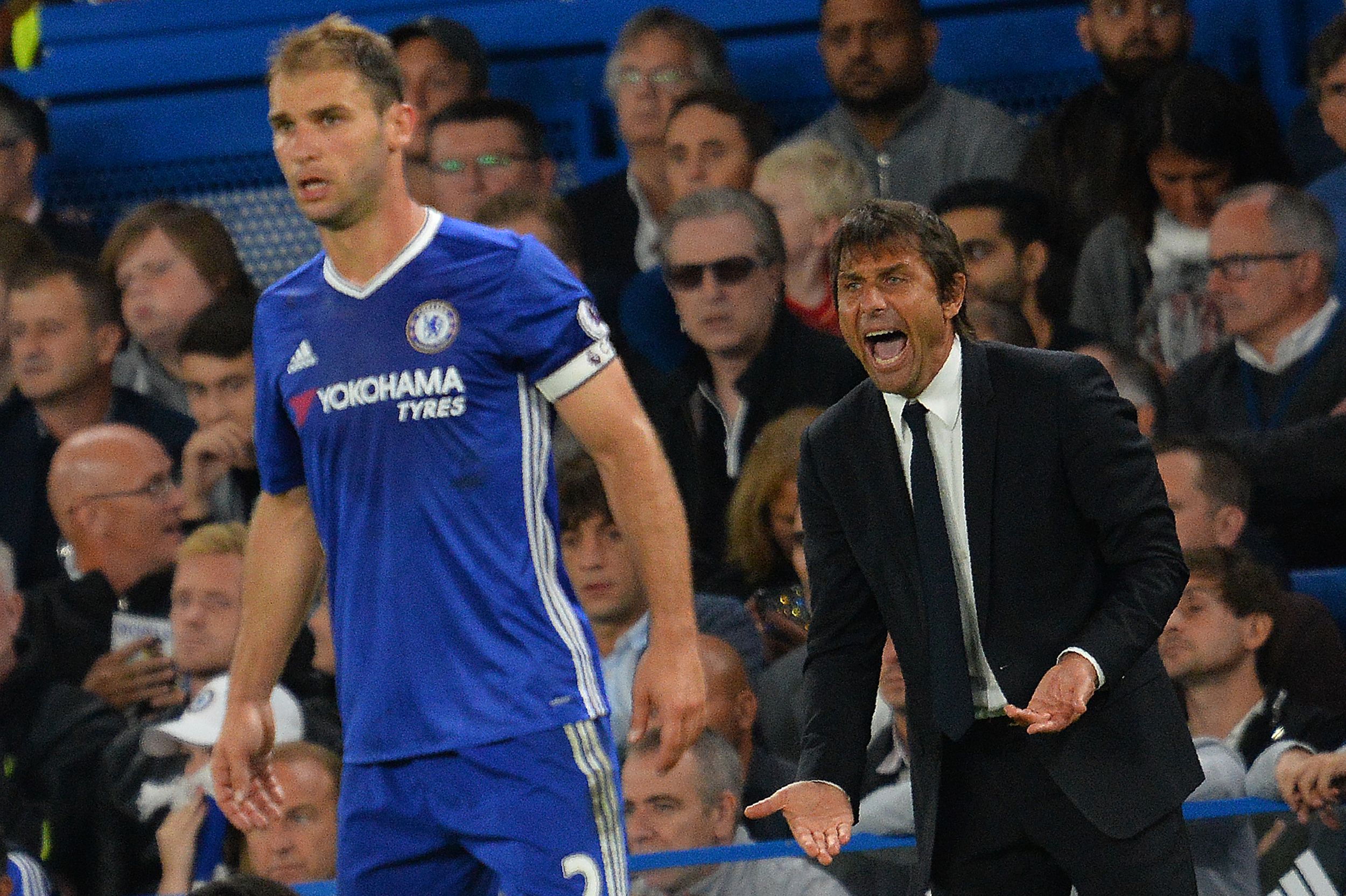 Chelsea's Italian head coach Antonio Conte (R) shouts at Chelsea's Serbian defender Branislav Ivanovic during the English Premier League football match between Chelsea and Liverpool at Stamford Bridge in London on September 16, 2016.      (Photo by Glyn Kirk/AFP/Getty Images)