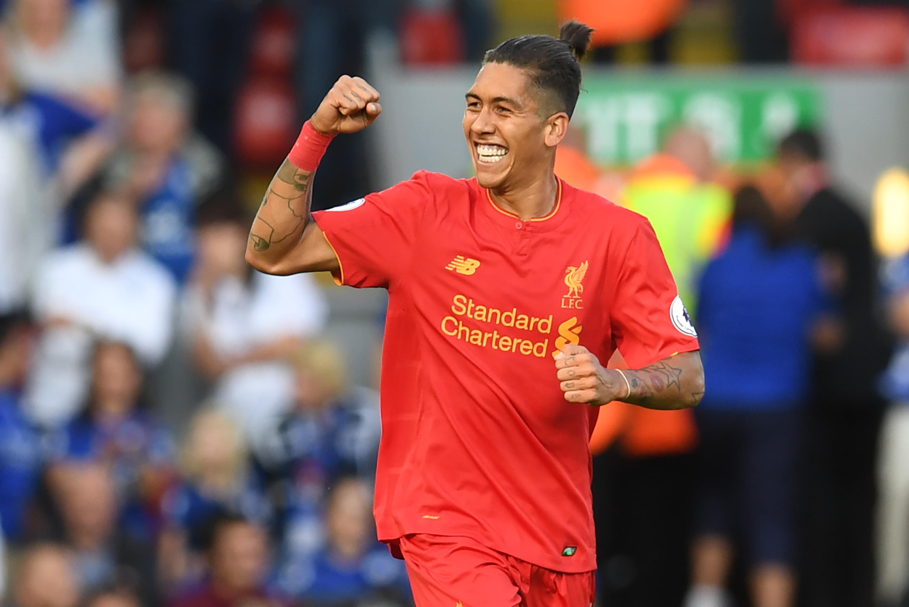 Liverpool's Brazilian midfielder Roberto Firmino celebrates after scoring the opening goal of the English Premier League football match between Liverpool and Leicester City at Anfield in Liverpool, north west England on September 10, 2016. / AFP / Paul ELLIS / RESTRICTED TO EDITORIAL USE. No use with unauthorized audio, video, data, fixture lists, club/league logos or 'live' services. Online in-match use limited to 75 images, no video emulation. No use in betting, games or single club/league/player publications.  /         (Photo credit should read PAUL ELLIS/AFP/Getty Images)