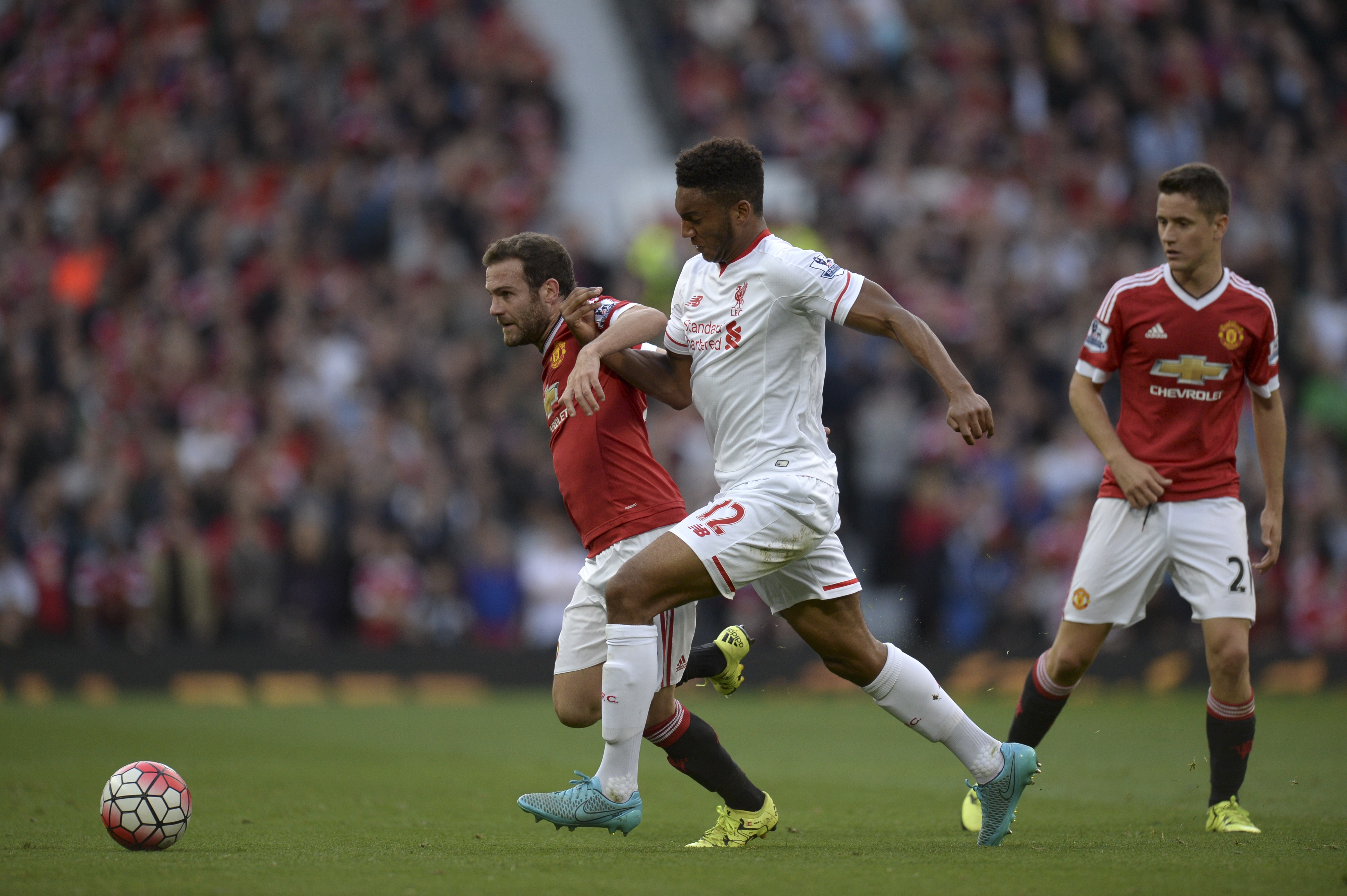Manchester United's Spanish midfielder Juan Mata (L) vies with Liverpool's English defender Joe Gomez (C) during the English Premier League football match between Manchester United and Liverpool at Old Trafford in Manchester, north west England, on September 12, 2015. AFP PHOTO / OLI SCARFF

RESTRICTED TO EDITORIAL USE. No use with unauthorized audio, video, data, fixture lists, club/league logos or 'live' services. Online in-match use limited to 75 images, no video emulation. No use in betting, games or single club/league/player publications.        (Photo credit should read OLI SCARFF/AFP/Getty Images)