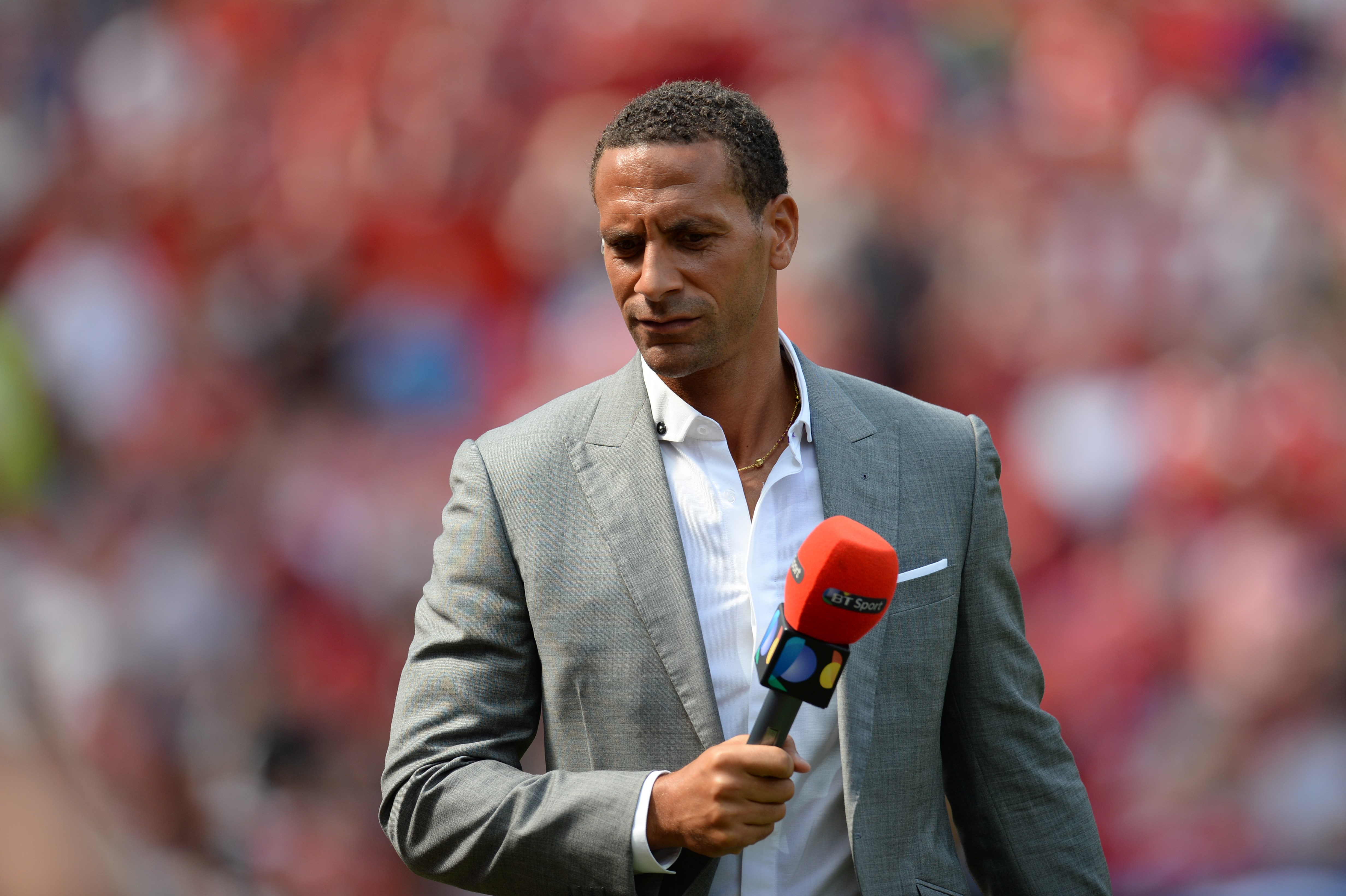 Former Manchester United defender Rio Ferdinand, working as a Television pundit is pictured ahead of the English Premier League football match between Manchester United and Tottenham Hotspur at Old Trafford in Manchester, north west England, on August 8, 2015. AFP PHOTO / OLI SCARFF

RESTRICTED TO EDITORIAL USE. No use with unauthorized audio, video, data, fixture lists, club/league logos or 'live' services. Online in-match use limited to 75 images, no video emulation. No use in betting, games or single club/league/player publications.        (Photo credit should read OLI SCARFF/AFP/Getty Images)