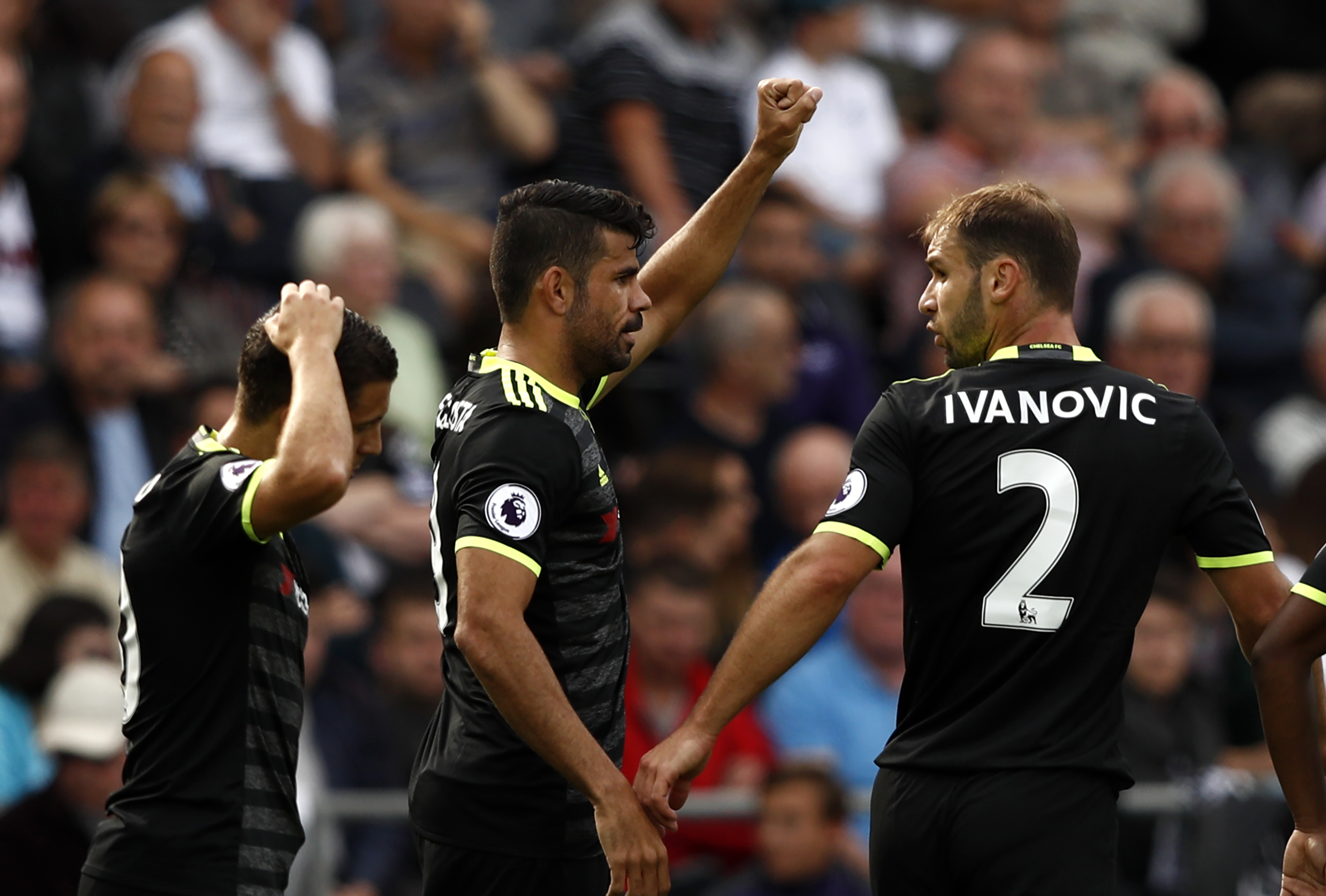 Chelsea's Brazilian-born Spanish striker Diego Costa (C) celebrates after scoring the opening goal of the English Premier League football match between Swansea City and Chelsea at The Liberty Stadium in Swansea, south Wales on September 11, 2016. / AFP / Adrian DENNIS / RESTRICTED TO EDITORIAL USE. No use with unauthorized audio, video, data, fixture lists, club/league logos or 'live' services. Online in-match use limited to 75 images, no video emulation. No use in betting, games or single club/league/player publications.  /         (Photo credit should read ADRIAN DENNIS/AFP/Getty Images)