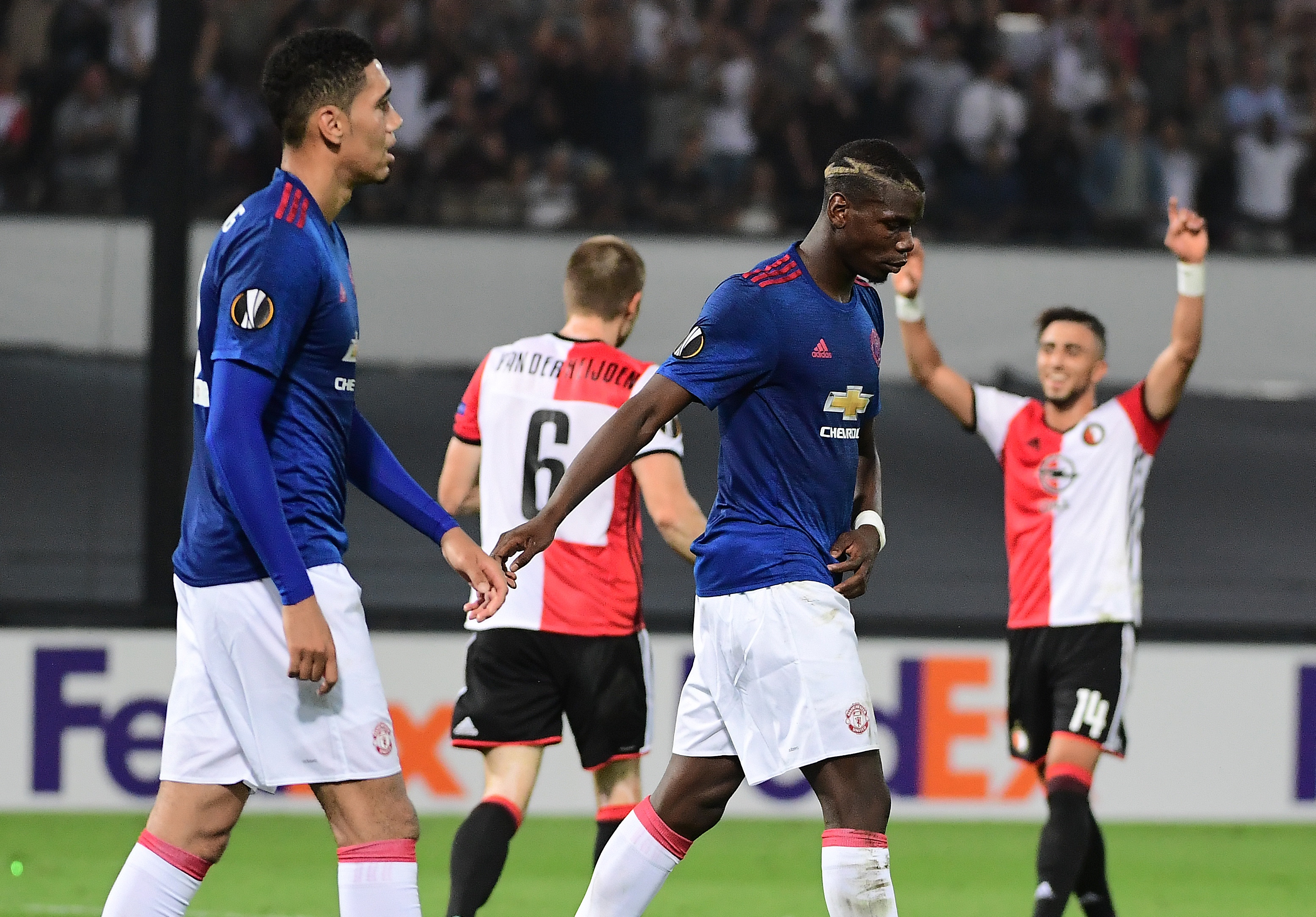 Manchester United's Paul Pogba (C) and  Chris Smalling react after losing the UEFA Europa League football match between Feyenoord Rotterdam and Manchester United at the Feyenoord Stadium in Rotterdam on September 15, 2016.
Feyenoord won the match 1-0. (Photo by Emmanuel Dunand/AFP/Getty Images)