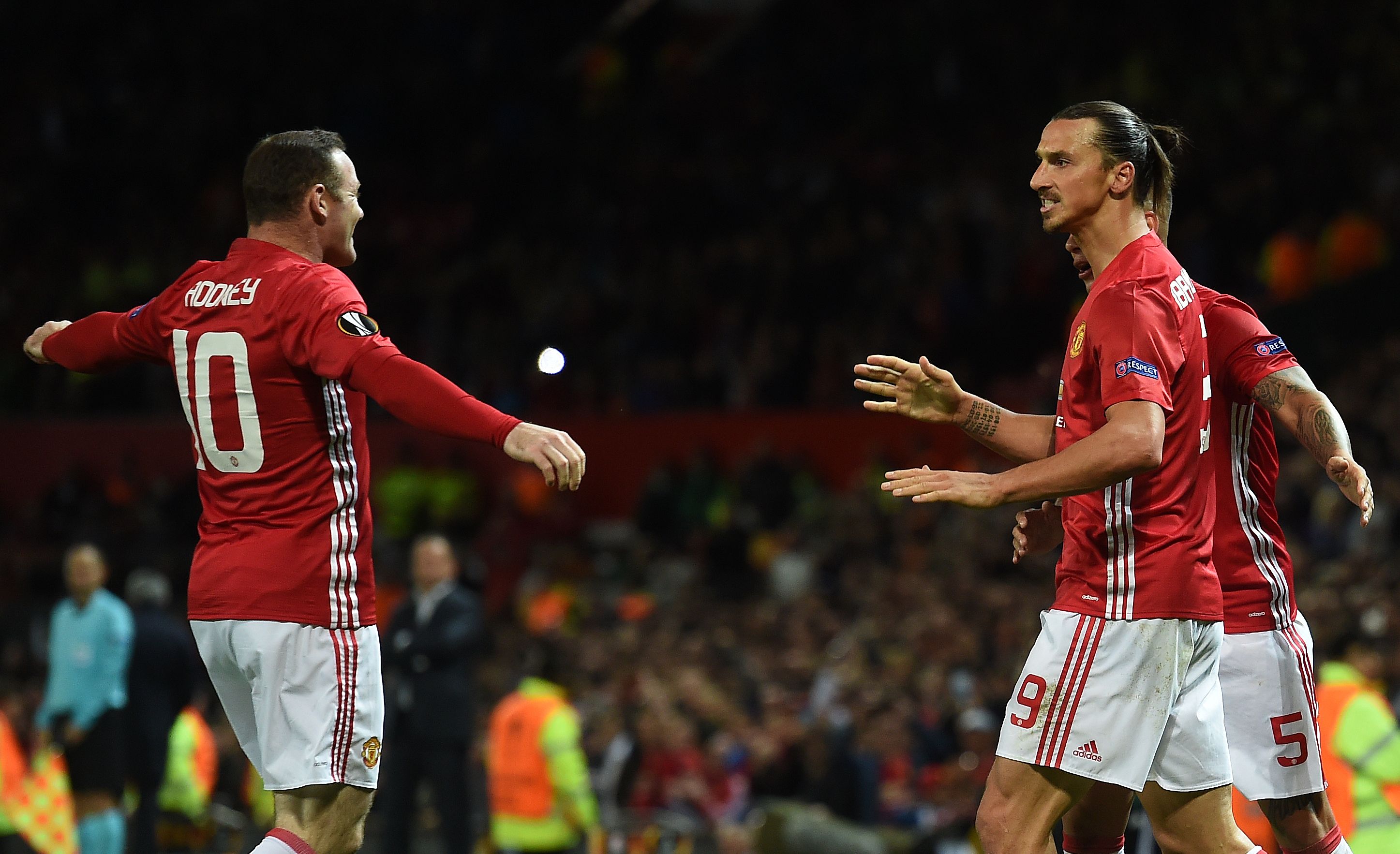 Manchester United's Swedish striker Zlatan Ibrahimovic (R) celebrates scoring his team's first goal with Manchester United's English striker Wayne Rooney (L) during the UEFA Europa League group A football match between Manchester United and Zorya Luhansk at Old Trafford stadium in Manchester, north-west England on September 29, 2016. / AFP / PAUL ELLIS        (Photo credit should read PAUL ELLIS/AFP/Getty Images)