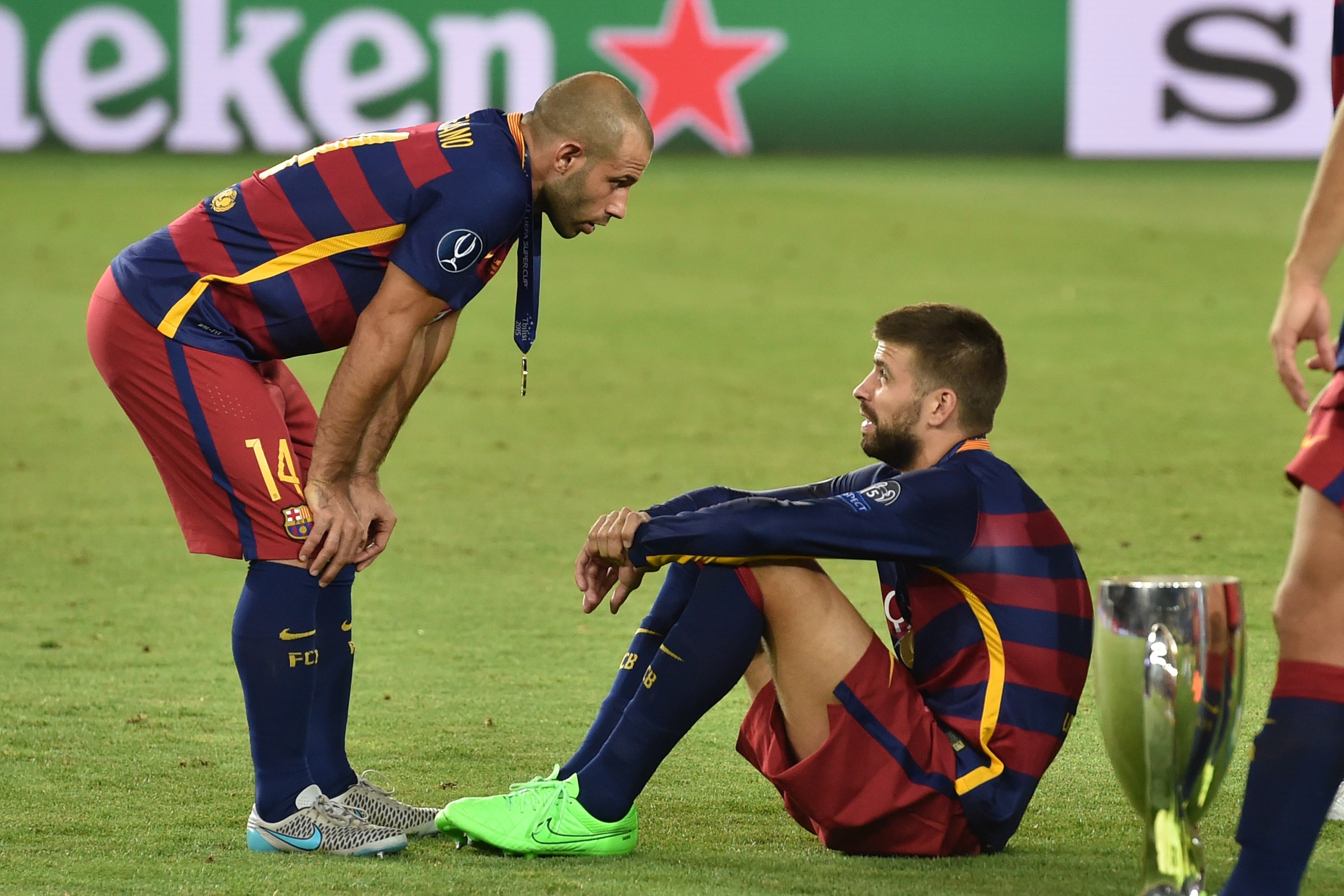 Barcelona's Spanish defender Gerard Pique and Barcelona's Argentinian defender Javier Mascherano (L) react after winning the UEFA Super Cup final football match between FC Barcelona and Sevilla FC on August 11, 2015 at the Boris Paichadze Dinamo Arena in Tbilisi. AFP PHOTO / KIRILL KUDRYAVTSEV        (Photo credit should read KIRILL KUDRYAVTSEV/AFP/Getty Images)