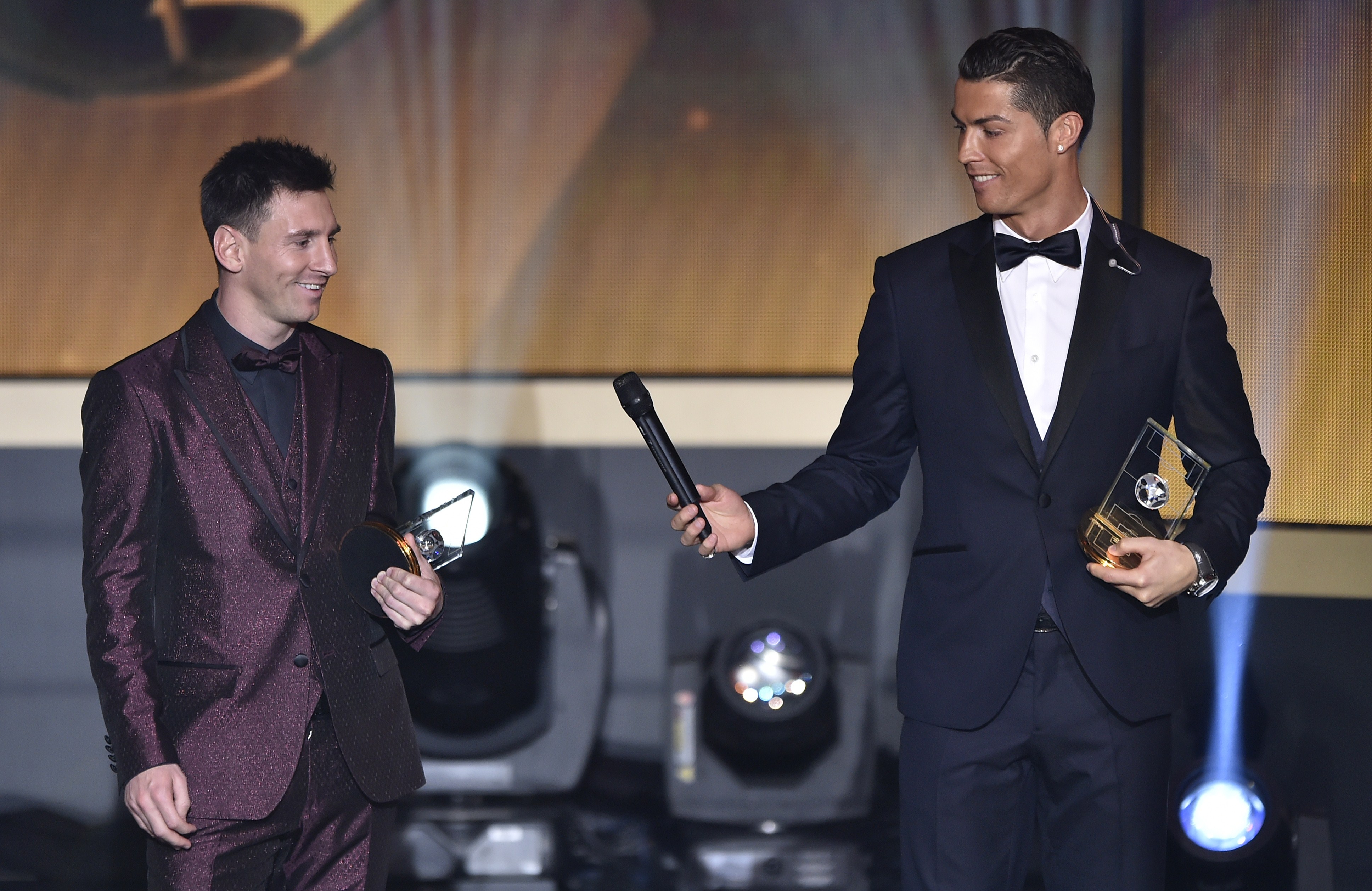 Luis Figo has said that it would not be too far-fetched to envision Ronaldo passing the ball to Messi and vice-versa in the same way the Portuguese international appears to passing the mike on to the Argentinian in the above image. (Picture Courtesy - AFP/Getty Images)