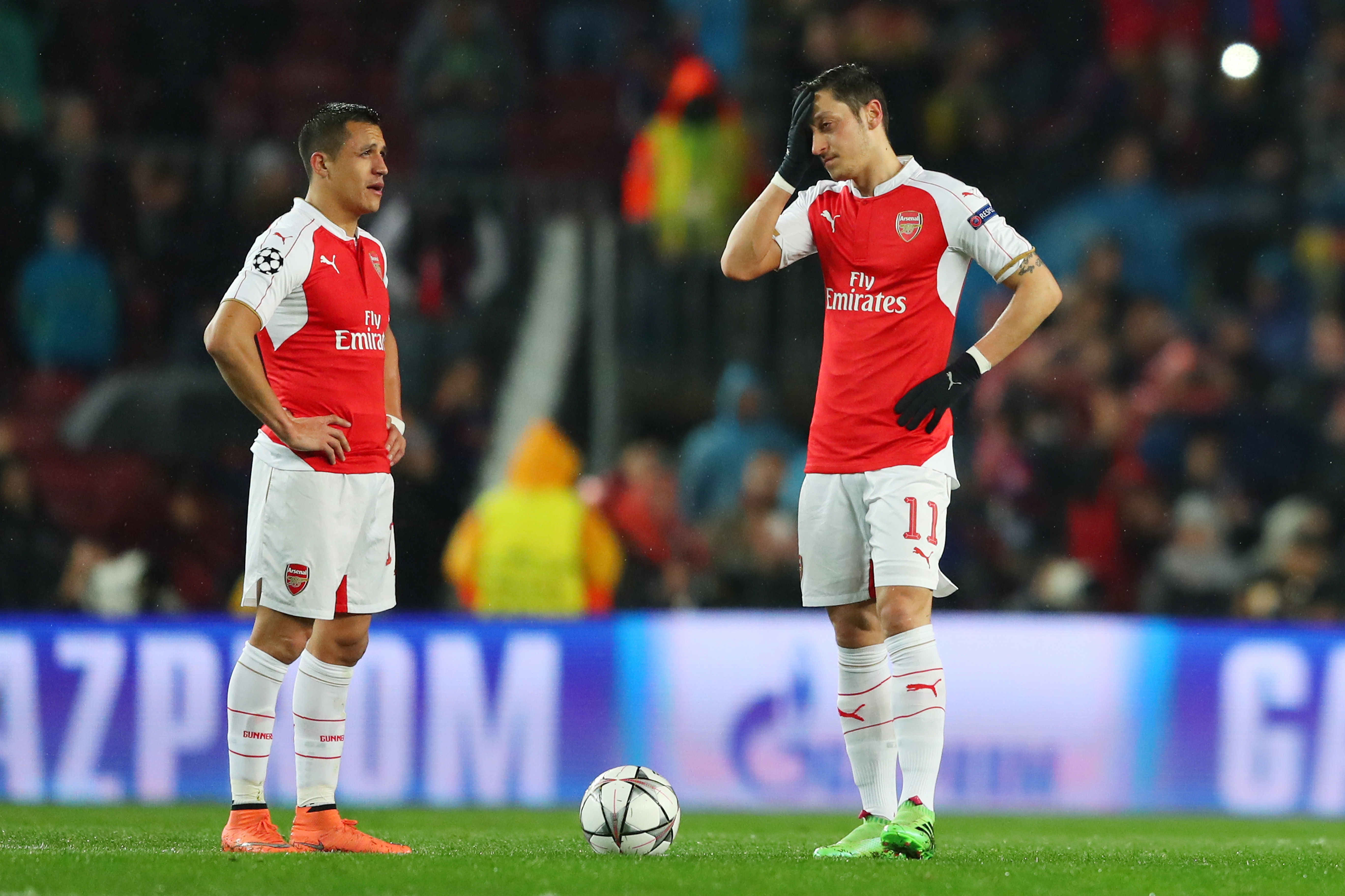 BARCELONA, SPAIN - MARCH 16: Alexis Sanchez (L) and Mesut Ozil (R) of Arsenal show their dejection after Barcelona's first goal during the UEFA Champions League round of 16, second Leg match between FC Barcelona and Arsenal FC at Camp Nou on March 16, 2016 in Barcelona, Spain.  (Photo by Richard Heathcote/Getty Images)