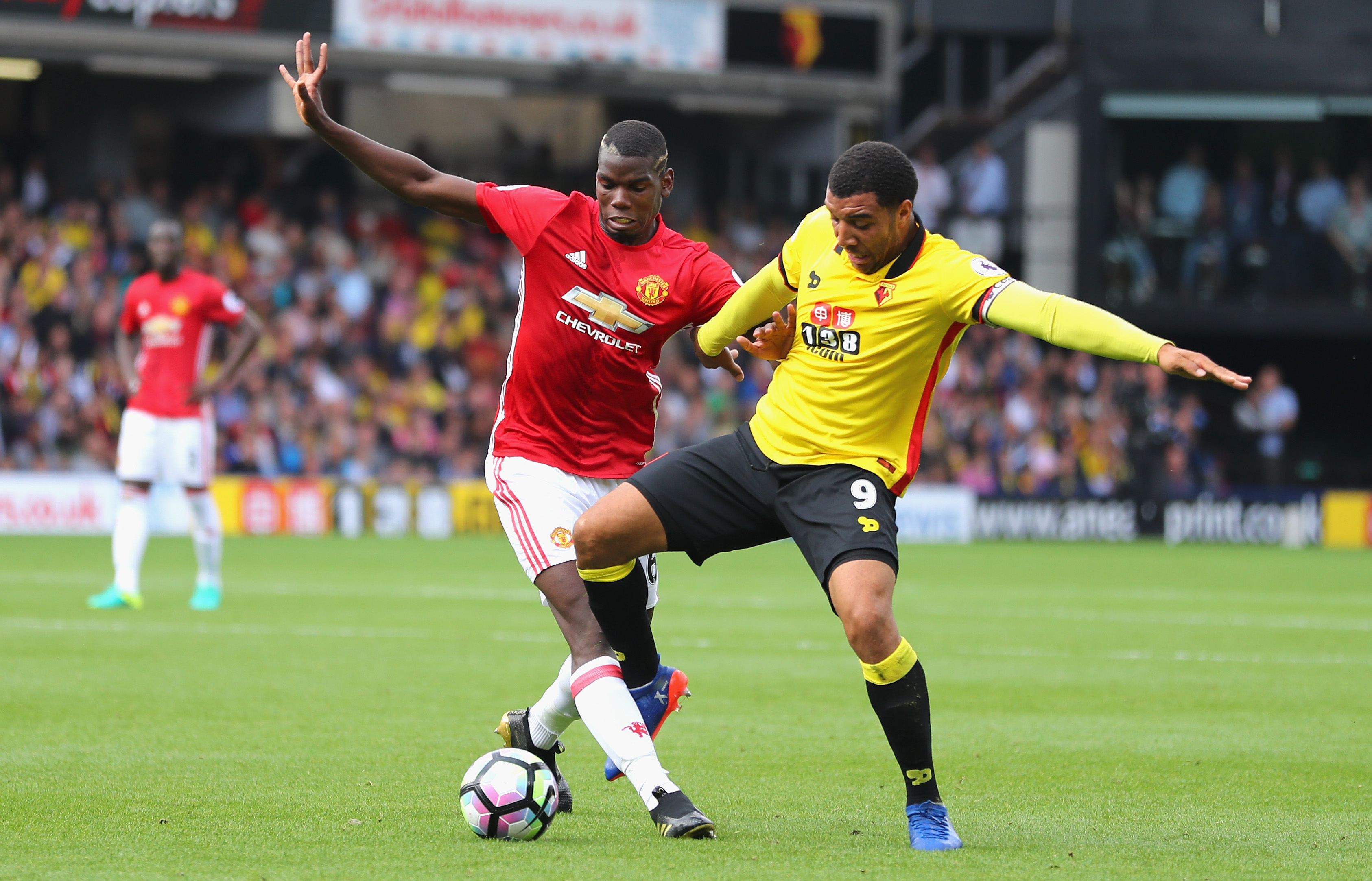 WATFORD, ENGLAND - SEPTEMBER 18: Paul Pogba of Manchester United (L) and Troy Deeney of Watford (R) battle for possession during the Premier League match between Watford and Manchester United at Vicarage Road on September 18, 2016 in Watford, England.  (Photo by Richard Heathcote/Getty Images)