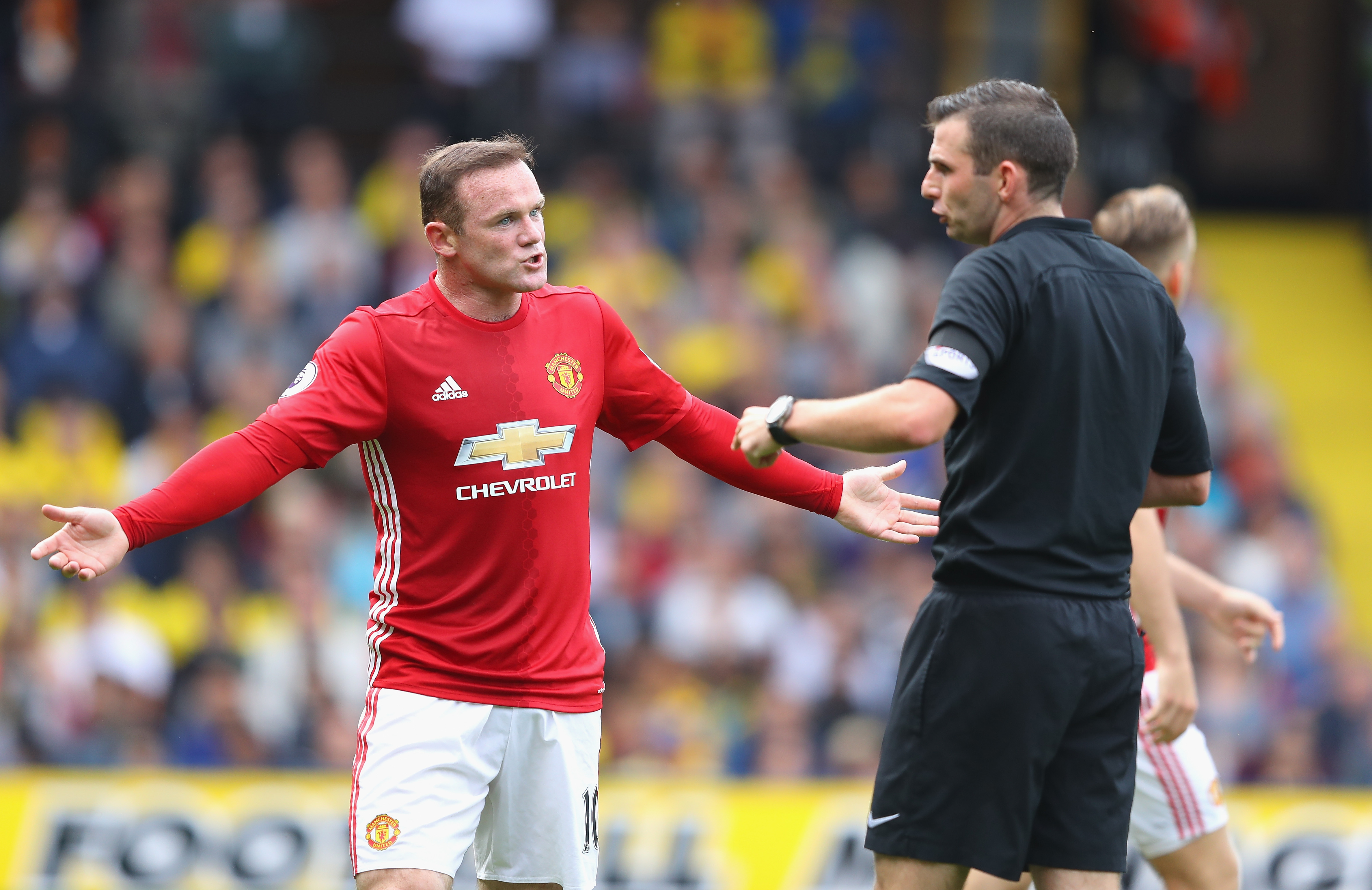 WATFORD, ENGLAND - SEPTEMBER 18: Wayne Rooney of Manchester United (L) argues with referee Michael Oliver during the Premier League match between Watford and Manchester United at Vicarage Road on September 18, 2016 in Watford, England.  (Photo by Richard Heathcote/Getty Images)