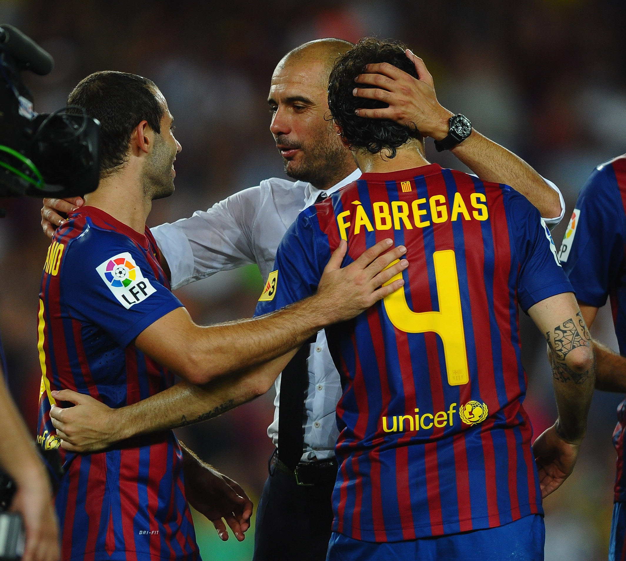 BARCELONA, SPAIN - AUGUST 17: Josep Guardiola  of Barcelona congratulates Cesc Fabregas and Javier Mascherano after victory in the Super Cup second leg match between Barcelona and Real Madrid at Nou Camp on August 17, 2011 in Barcelona, Spain.  (Photo by Laurence Griffiths/Getty Images)