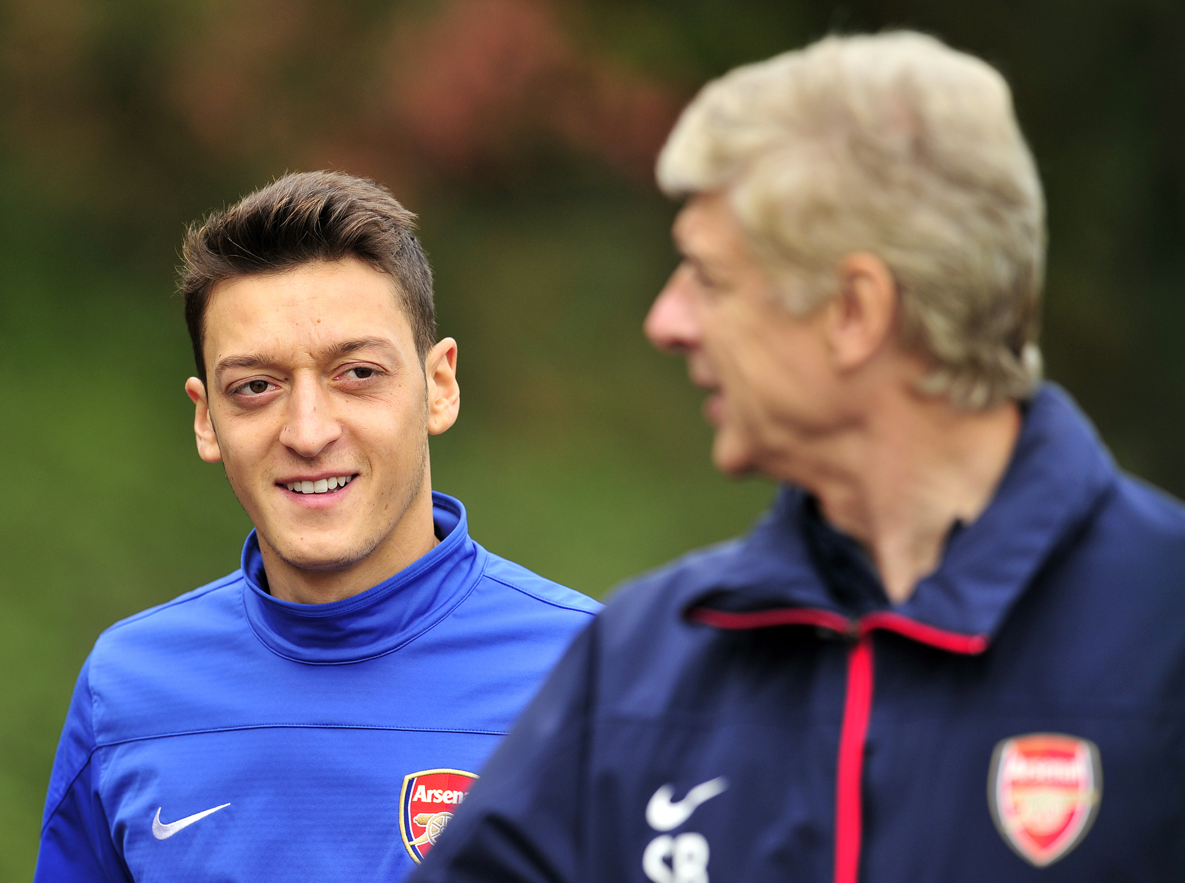 Mutual admiration. (Picture CoArsenal's German midfielder Mesut Ozil (L) and French manager Arsene Wenger (R) speak during a team training session at Arsenal's London Colney training ground in north London.       (Photo by Glyn Kirk/AFP/Getty Images)