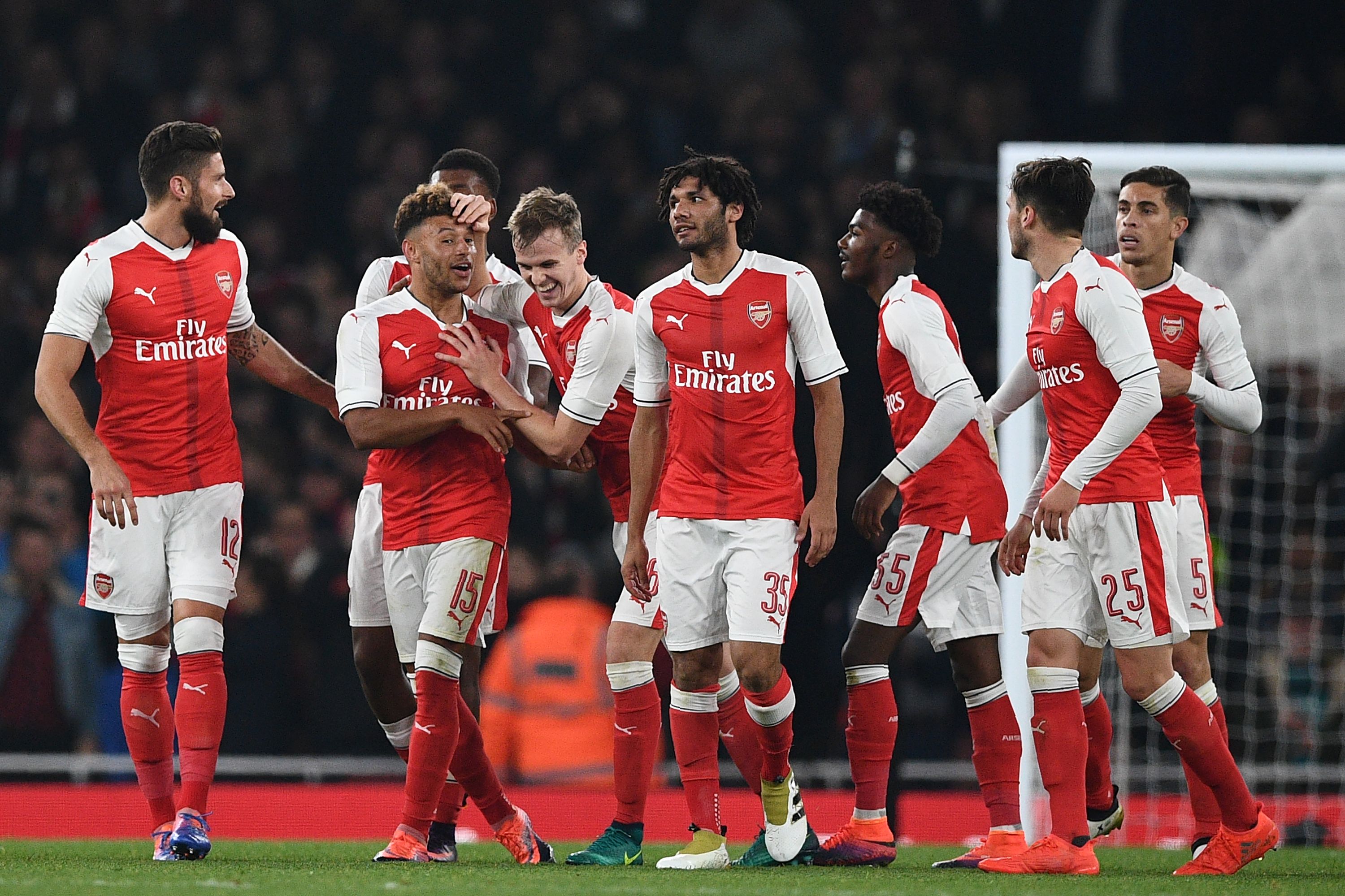 Arsenal's English midfielder Alex Oxlade-Chamberlain (2nd L) celebrates with teammates after scoring their second goal during the EFL (English Football League) Cup fourth round match between Arsenal and Reading at The Emirates Stadium in London on October 25, 2016.
Arsenal won the game 2-0. / AFP / Justin TALLIS / RESTRICTED TO EDITORIAL USE. No use with unauthorized audio, video, data, fixture lists, club/league logos or 'live' services. Online in-match use limited to 75 images, no video emulation. No use in betting, games or single club/league/player publications.  /         (Photo credit should read JUSTIN TALLIS/AFP/Getty Images)