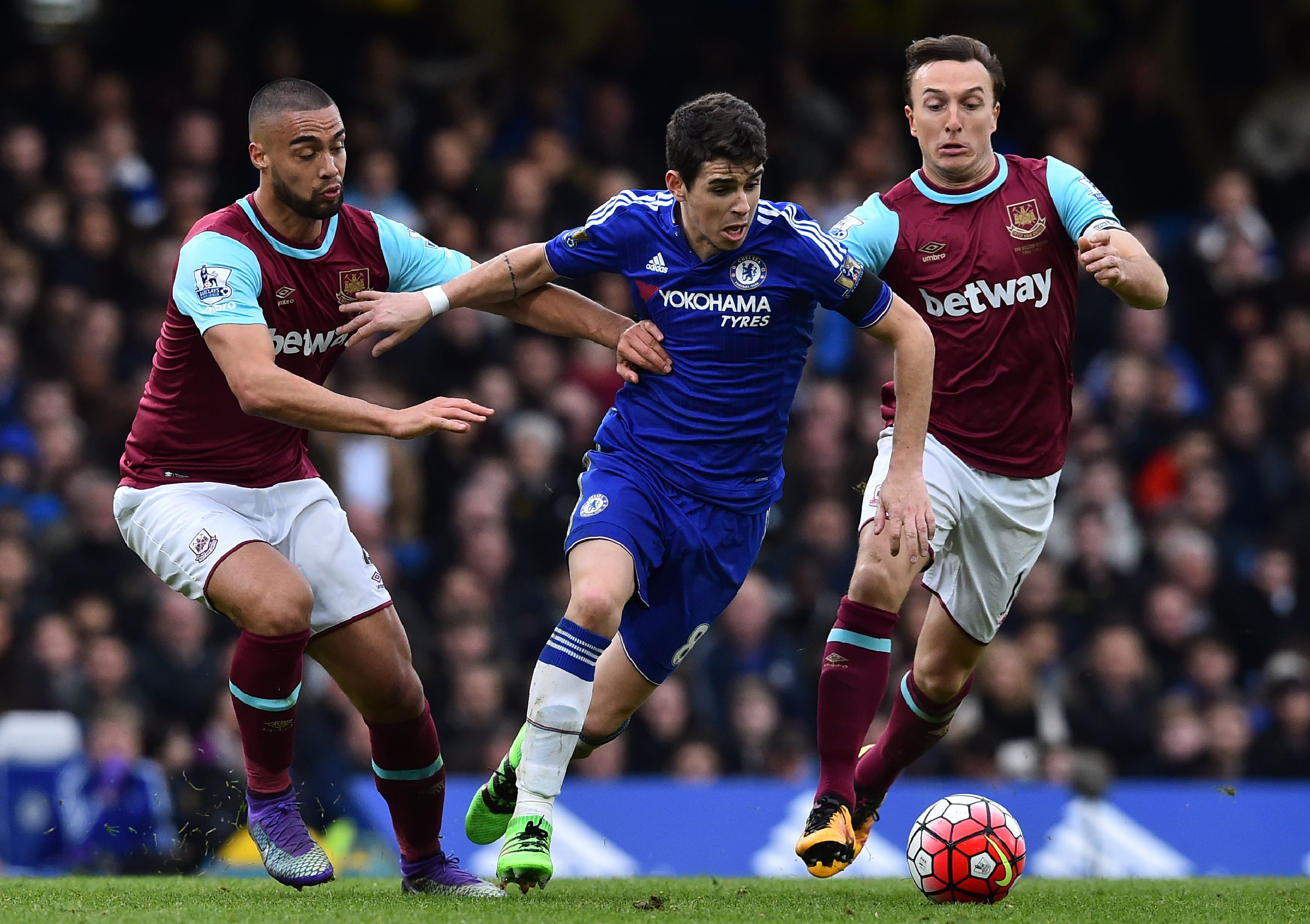 Chelsea's Brazilian midfielder Oscar (C) vies with West Ham United's New Zealand defender Winston Reid (L) and West Ham United's English midfielder Mark Noble during the English Premier League football match between Chelsea and West Ham United at Stamford Bridge in London on March 19, 2016.
The game finished 2-2. / AFP / Ben STANSALL / RESTRICTED TO EDITORIAL USE. No use with unauthorized audio, video, data, fixture lists, club/league logos or 'live' services. Online in-match use limited to 75 images, no video emulation. No use in betting, games or single club/league/player publications.  /         (Photo credit should read BEN STANSALL/AFP/Getty Images)