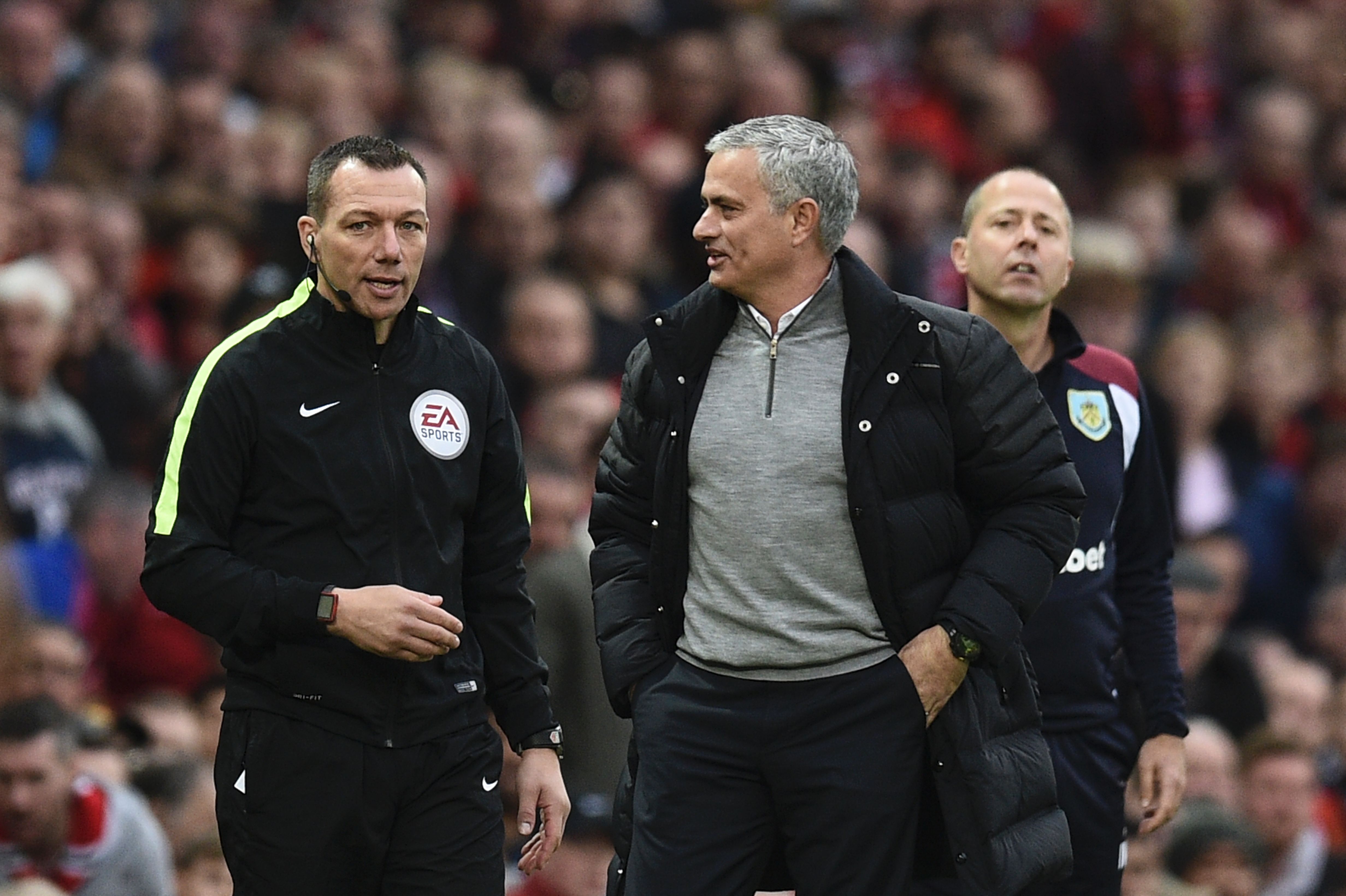 Manchester United's Portuguese manager Jose Mourinho (R) talks with fourth official Kevin Friend (L) on the touchline during the English Premier League football match between Manchester United and Burnley at Old Trafford in Manchester, north west England, on October 29, 2016.    (Photo by Oli Scarff/AFP/Getty Images)
