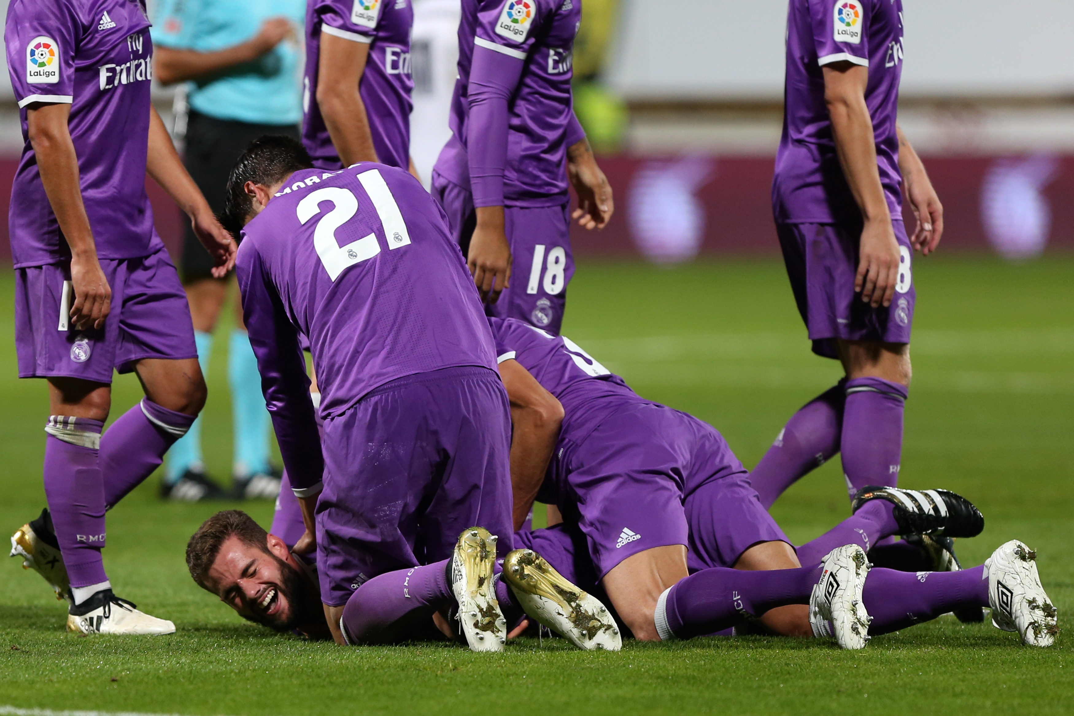 Real Madrid's defender Nacho Fernandez (Bottom) celebrates a goal with teammates during the Spanish Copa del Rey (King's Cup) round of 32 first leg football match between Cultural y Deportiva Leonesa and Real Madrid at the Reino de Leon stadium in Leon, on October 26, 2016. / AFP / CESAR MANSO        (Photo credit should read CESAR MANSO/AFP/Getty Images)