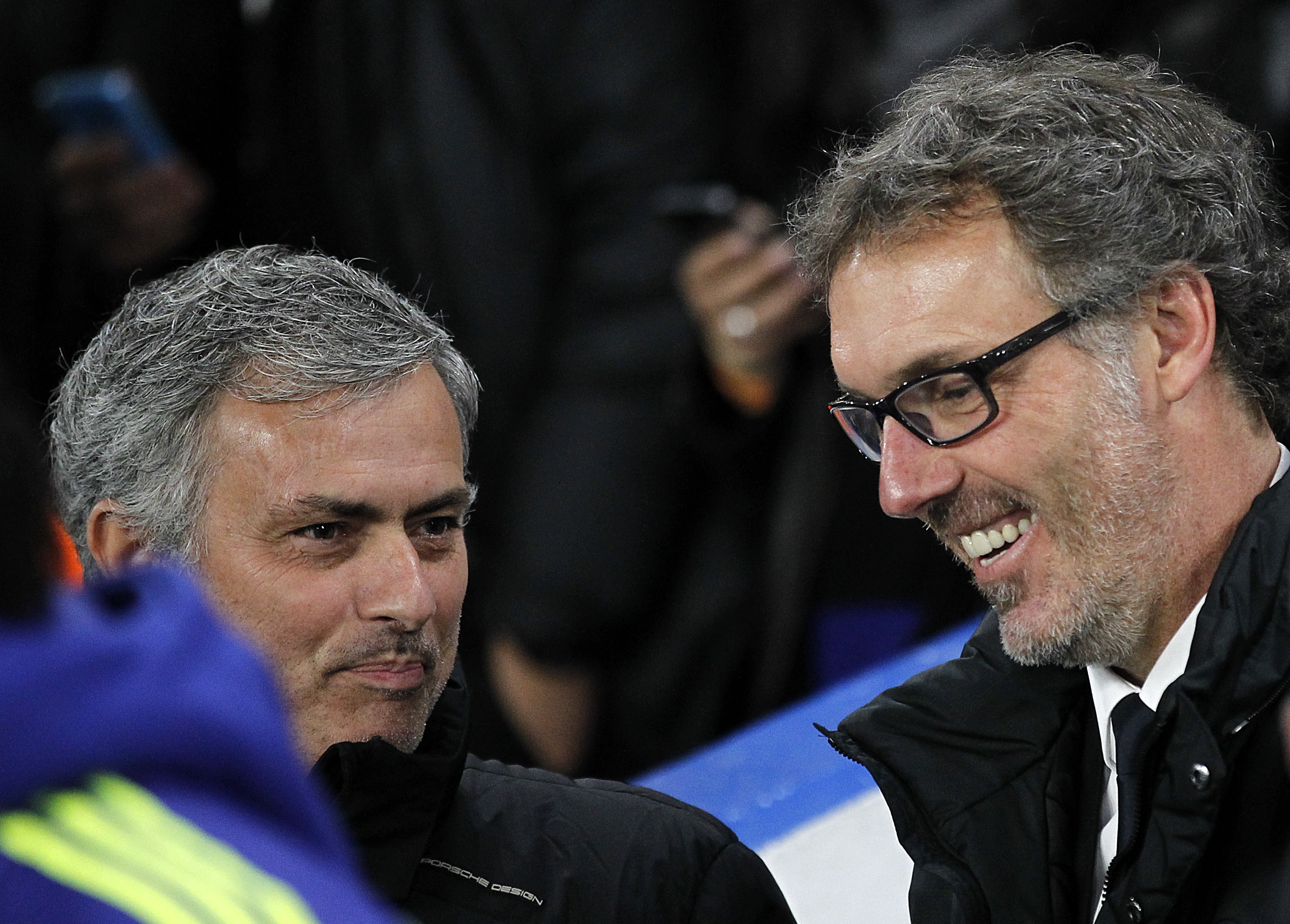 Paris Saint-Germain's French head coach Laurent Blanc (R) speaks with Chelsea's Portuguese manager Jose Mourinho before the start of the UEFA Champions League round of 16 second leg football match between Chelsea and Paris Saint-Germain at Stamford Bridge in London on March 11, 2015. AFP PHOTO / IAN KINGTON        (Photo credit should read IAN KINGTON/AFP/Getty Images)