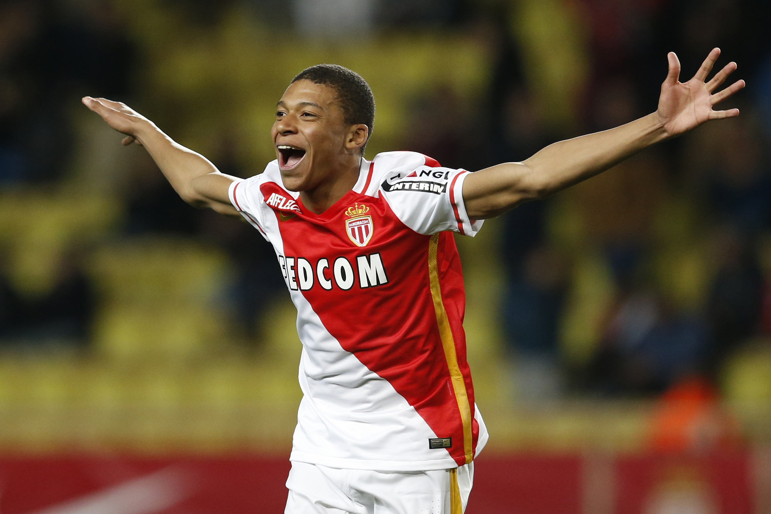 Monaco's French forward Kylian Mbappe Lottin celebrates after scoring a goal during the French L1 football match Monaco (ASM) vs Troyes (ESTAC) on February 20, 2016 at the "Louis II Stadium" in Monaco.  AFP PHOTO / VALERY HACHE / AFP / VALERY HACHE        (Photo credit should read VALERY HACHE/AFP/Getty Images)