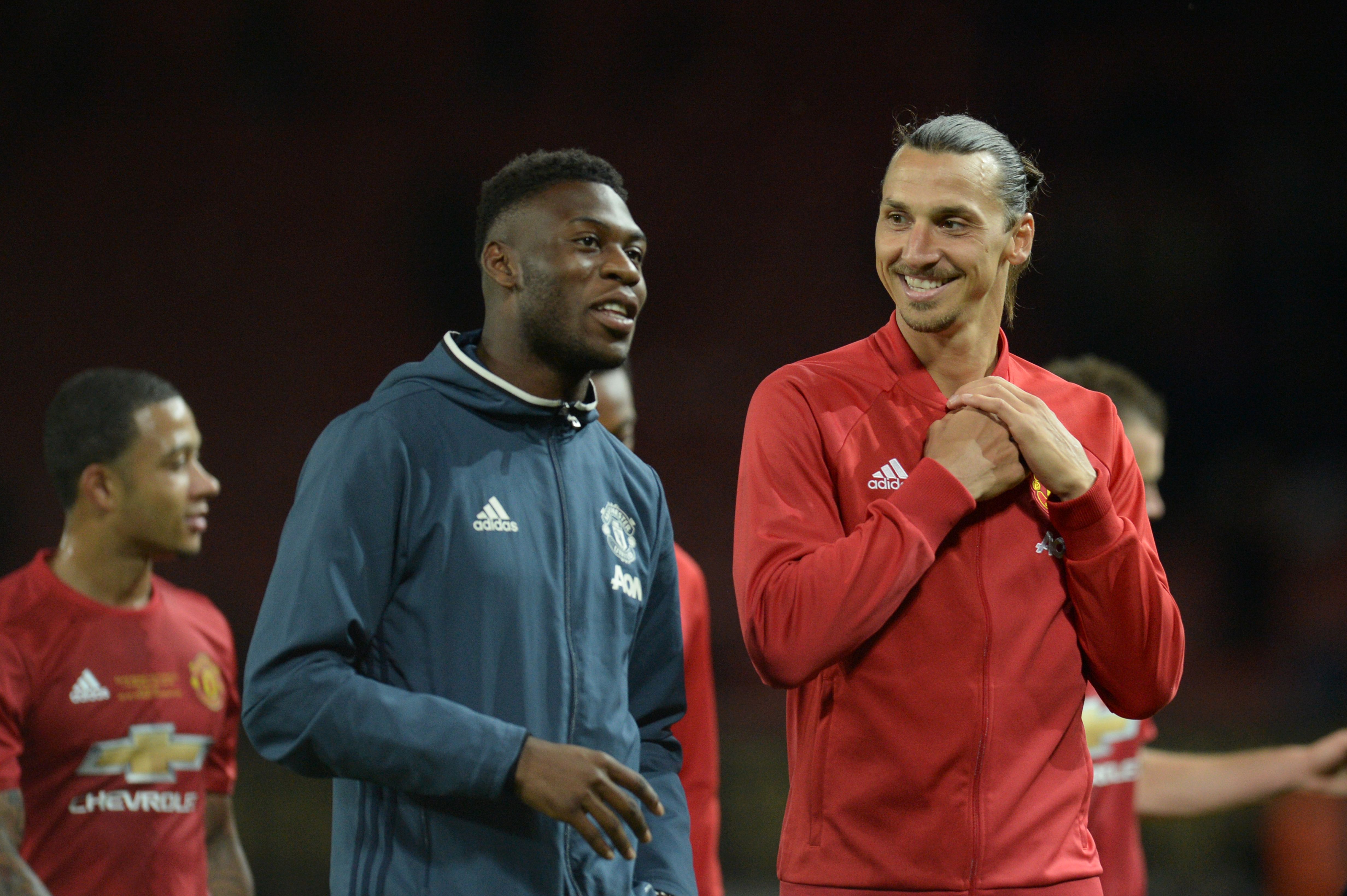 Manchester United's Swedish striker Zlatan Ibrahimovic (R) talks with Manchester United's Dutch defender Timothy Fosu-Mensah (L) at the end of the friendly Wayne Rooney testimonial football match between Manchester United and Everton at Old Trafford in Manchester, northwest England, on August 3, 2016.  / AFP / OLI SCARFF        (Photo credit should read OLI SCARFF/AFP/Getty Images)