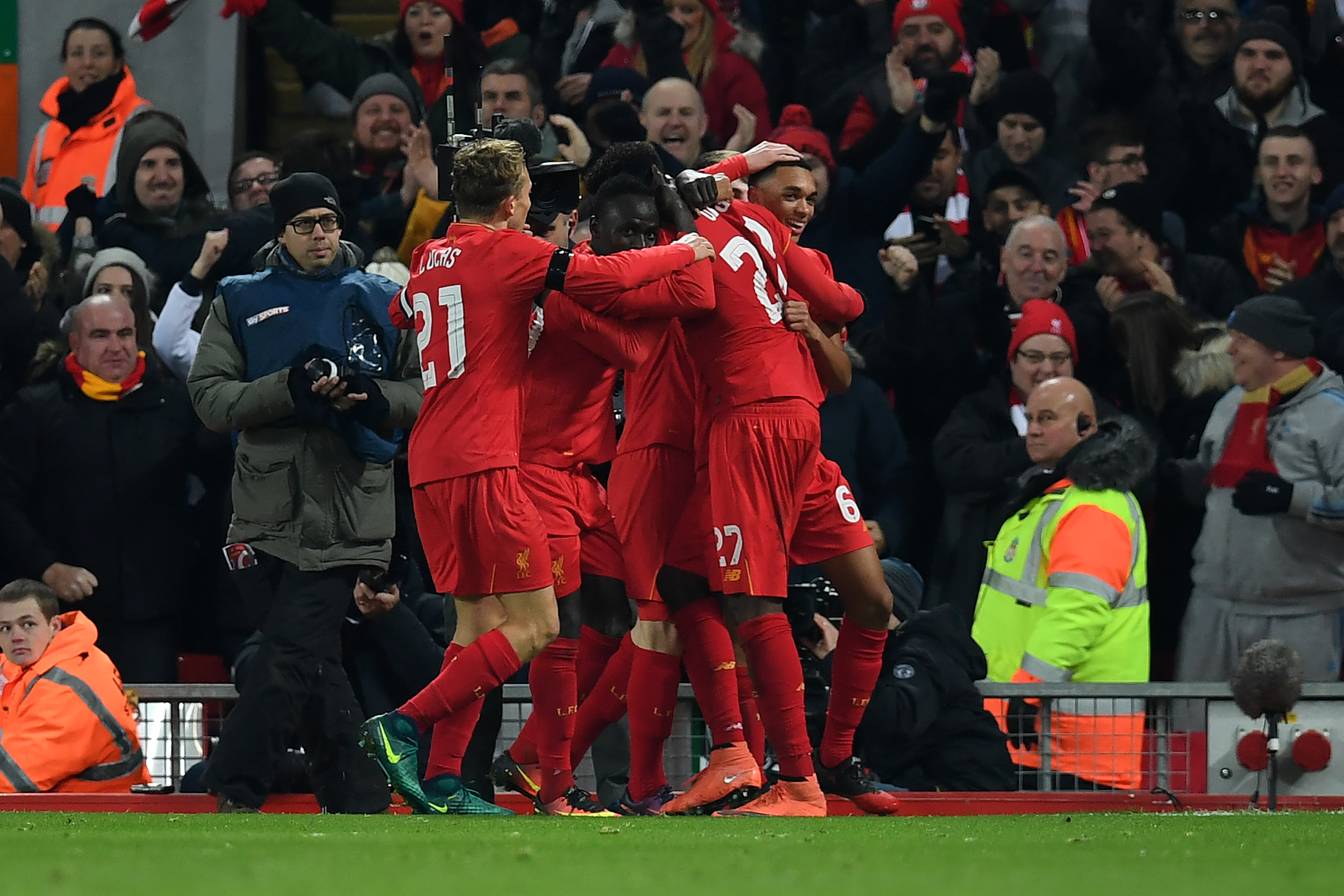 Liverpool's Belgian striker Divock Origi celebrates with teammates after scoring his team's first goal during the EFL (English Football League) Cup quarter-final football match between Liverpool and Leeds United at Anfield in Liverpool, north west England on November 29, 2016. / AFP / Paul ELLIS / RESTRICTED TO EDITORIAL USE. No use with unauthorized audio, video, data, fixture lists, club/league logos or 'live' services. Online in-match use limited to 75 images, no video emulation. No use in betting, games or single club/league/player publications.  /         (Photo credit should read PAUL ELLIS/AFP/Getty Images)