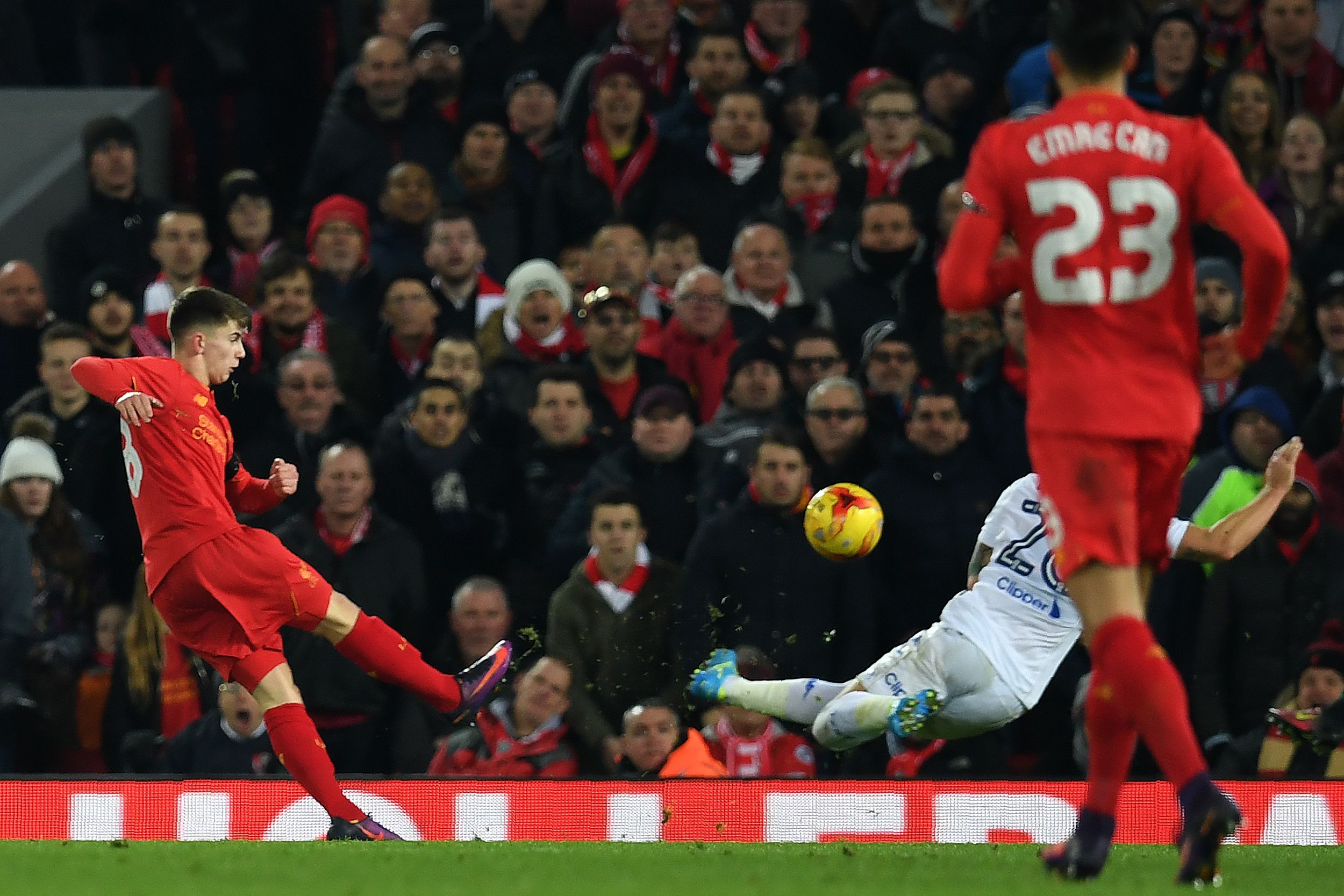 Liverpool's Welsh striker Ben Woodburn scores his team's second goal during the EFL (English Football League) Cup quarter-final football match between Liverpool and Leeds United at Anfield in Liverpool, north west England on November 29, 2016. / AFP / Paul ELLIS / RESTRICTED TO EDITORIAL USE. No use with unauthorized audio, video, data, fixture lists, club/league logos or 'live' services. Online in-match use limited to 75 images, no video emulation. No use in betting, games or single club/league/player publications.  /         (Photo credit should read PAUL ELLIS/AFP/Getty Images)