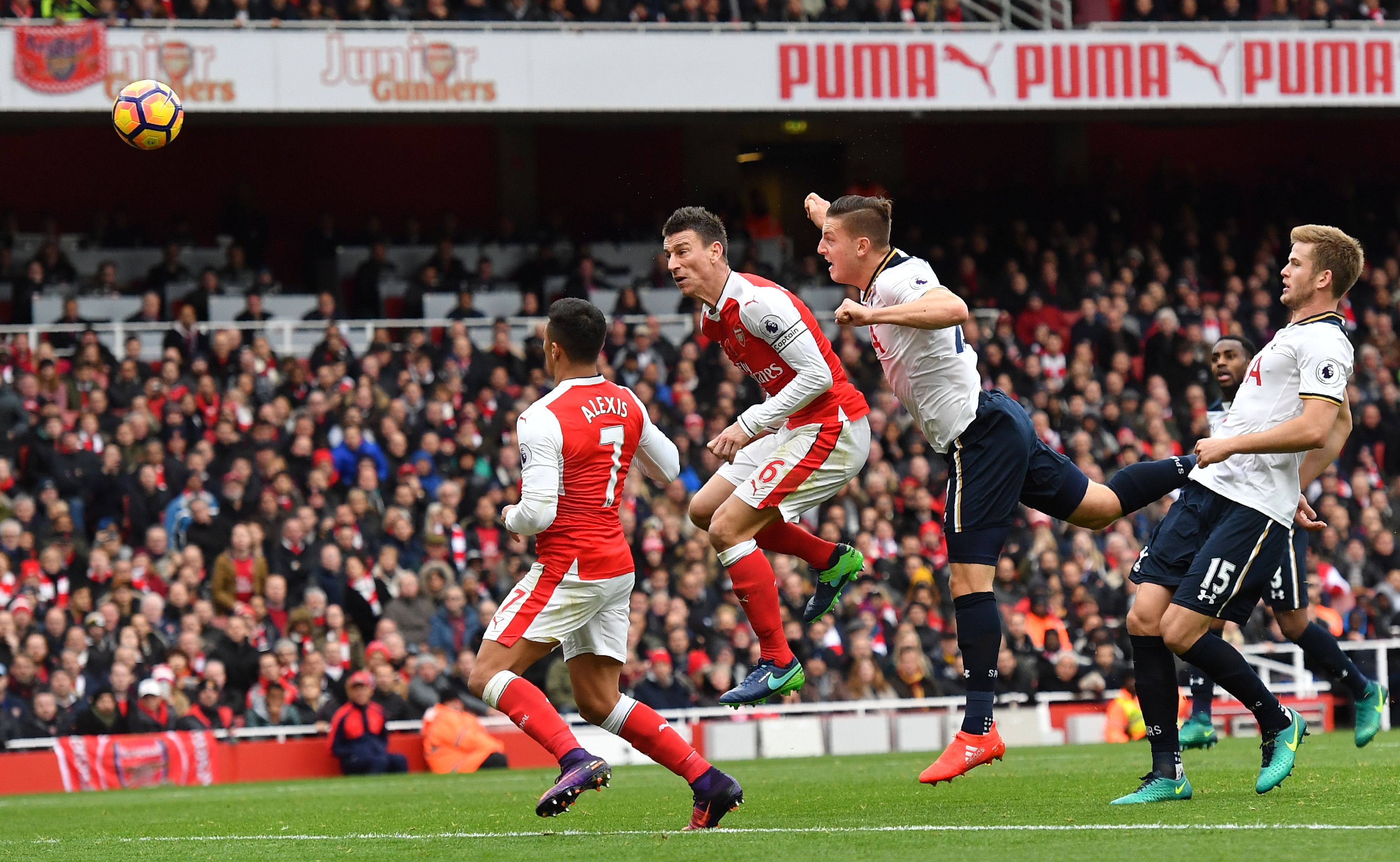 Tottenham Hotspur's Austrian defender Kevin Wimmer (2R) heads the ball past Arsenal's Chilean striker Alexis Sanchez (L) and Arsenal's French defender Laurent Koscielny (2L) to score an own goal during the English Premier League football match between Arsenal and Tottenham Hotspur at the Emirates Stadium in London on November 6, 2016.  / AFP / BEN STANSALL / RESTRICTED TO EDITORIAL USE. No use with unauthorized audio, video, data, fixture lists, club/league logos or 'live' services. Online in-match use limited to 75 images, no video emulation. No use in betting, games or single club/league/player publications.  /         (Photo credit should read BEN STANSALL/AFP/Getty Images)
