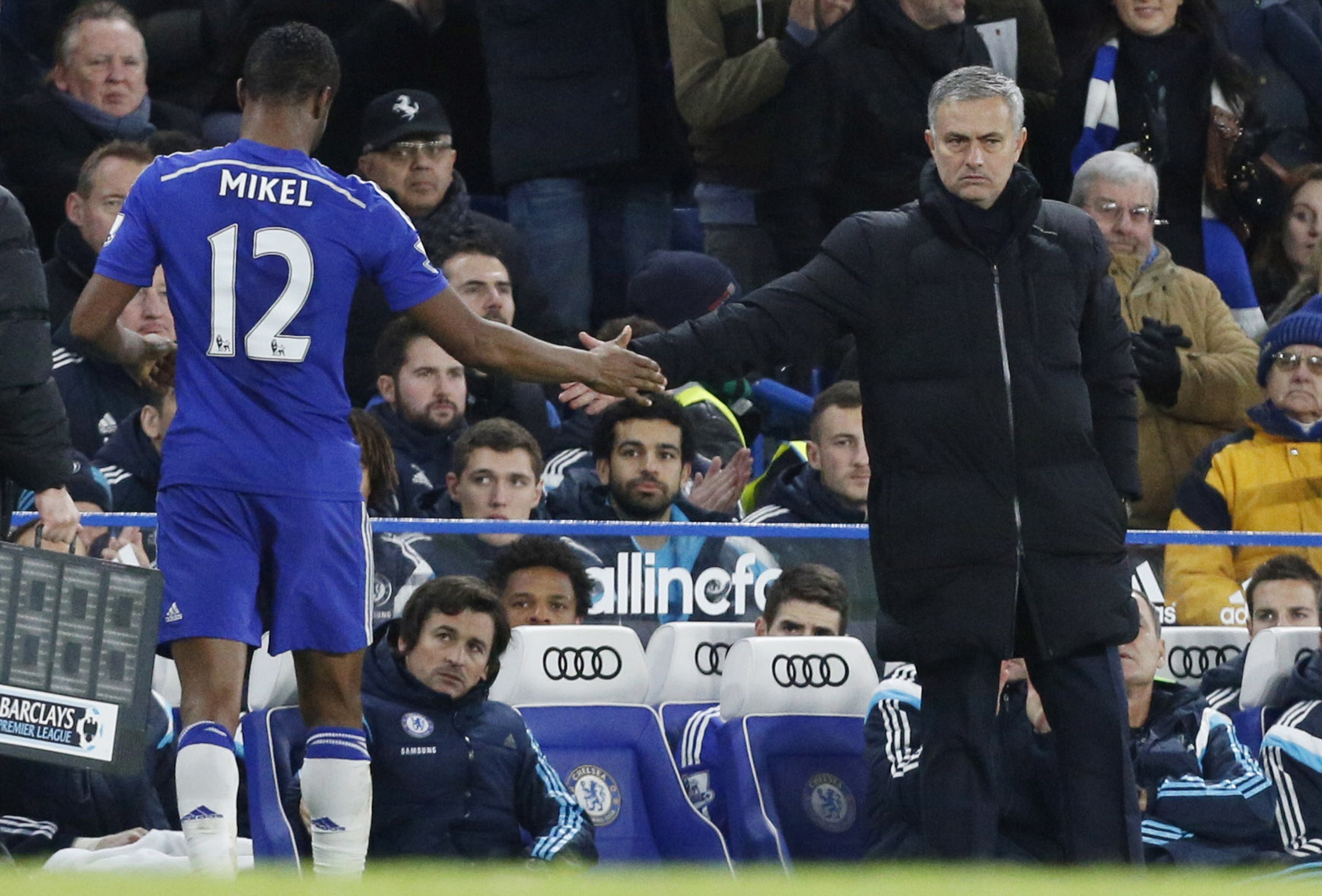 Chelsea's Nigerian midfielder John Obi Mikel (L) shakes hands with Chelsea's Portuguese manager Jose Mourinho (R) during the English Premier League football match between Chelsea and Hull City at Stamford Bridge in London on December 13, 2014. AFP PHOTO / JUSTIN TALLIS

RESTRICTED TO EDITORIAL USE. No use with unauthorized audio, video, data, fixture lists, club/league logos or live services. Online in-match use limited to 45 images, no video emulation. No use in betting, games or single club/league/player publications.        (Photo credit should read JUSTIN TALLIS/AFP/Getty Images)