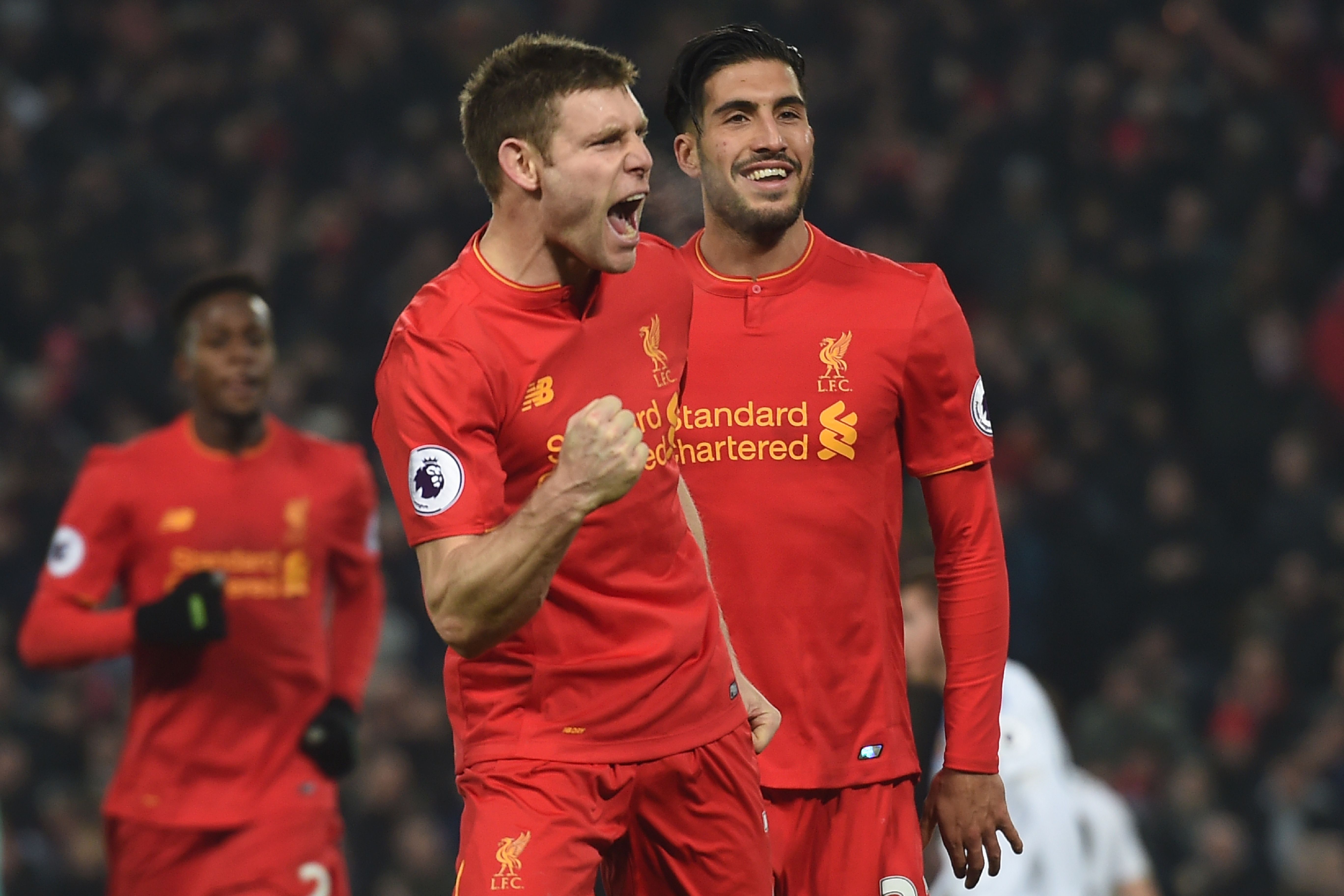 Liverpool's English midfielder James Milner (L) celebrates after scoring their second goal from the penalty spot with Liverpool's German midfielder Emre Can (R) during the English Premier League football match between Liverpool and Sunderland at Anfield in Liverpool, north west England on November 26, 2016. / AFP / Paul ELLIS / RESTRICTED TO EDITORIAL USE. No use with unauthorized audio, video, data, fixture lists, club/league logos or 'live' services. Online in-match use limited to 75 images, no video emulation. No use in betting, games or single club/league/player publications.  /         (Photo credit should read PAUL ELLIS/AFP/Getty Images)