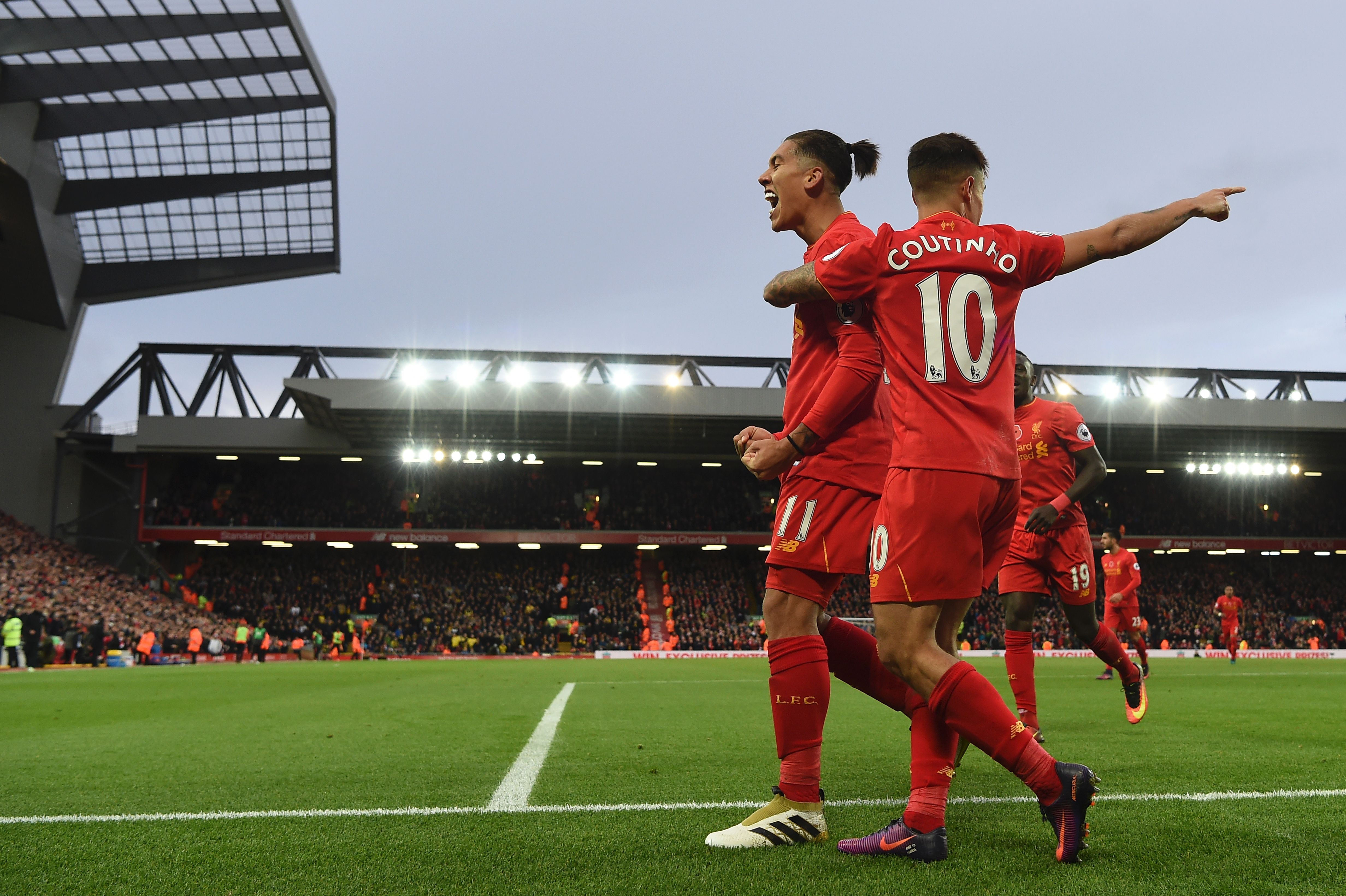 Liverpool's Brazilian midfielder Roberto Firmino (L) celebrates scoring his team's fourth goal Liverpool's Brazilian midfielder Philippe Coutinho with during the English Premier League football match between Liverpool and Watford at Anfield in Liverpool, north west England on November 6, 2016. / AFP / PAUL ELLIS / RESTRICTED TO EDITORIAL USE. No use with unauthorized audio, video, data, fixture lists, club/league logos or 'live' services. Online in-match use limited to 75 images, no video emulation. No use in betting, games or single club/league/player publications.  /         (Photo credit should read PAUL ELLIS/AFP/Getty Images)