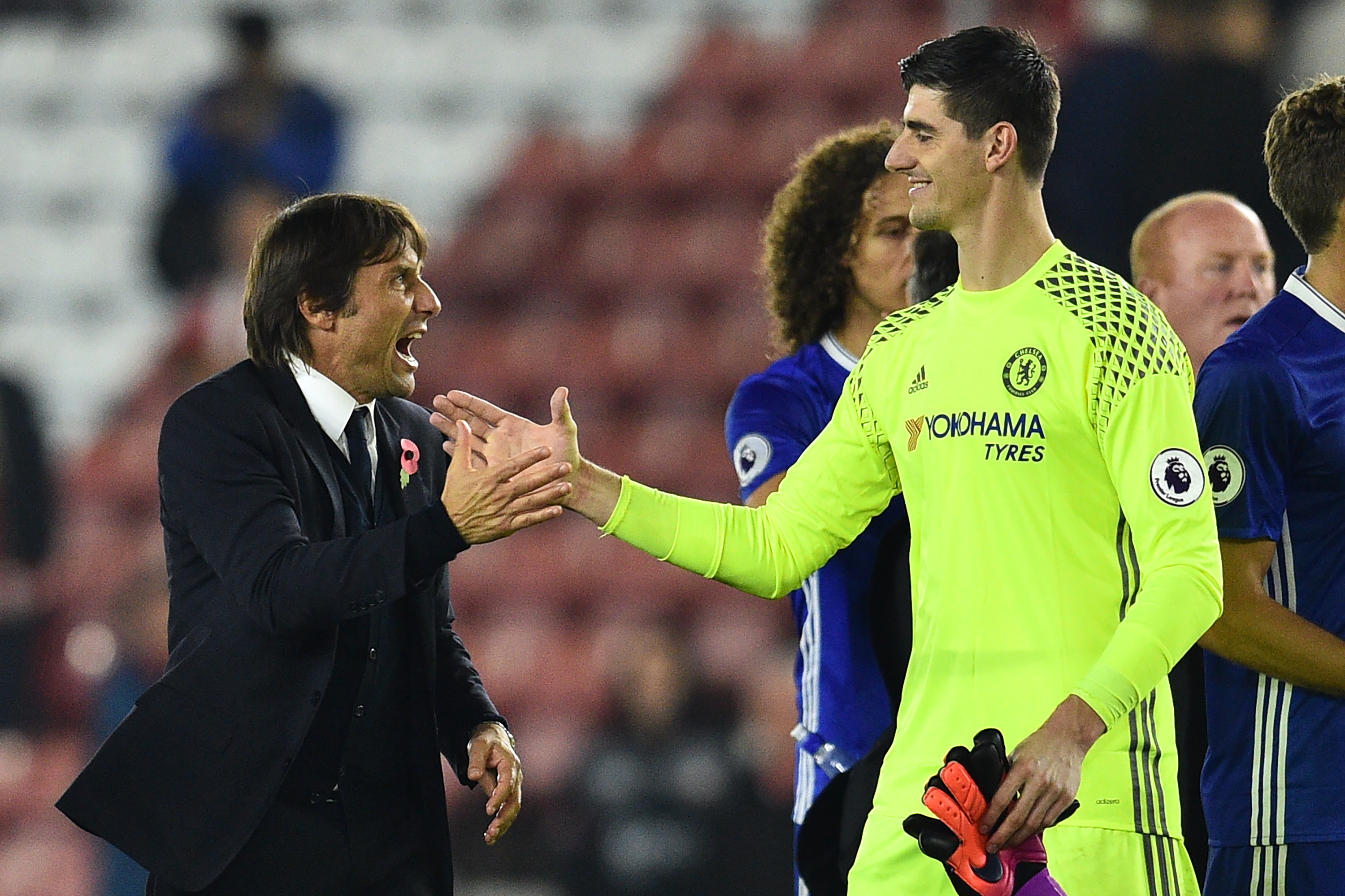Chelsea's Italian head coach Antonio Conte (L) celebrates with Chelsea's Belgian goalkeeper Thibaut Courtois on the pitch after the English Premier League football match between Southampton and Chelsea at St Mary's Stadium in Southampton, southern England on October 30, 2016.
Chelsea won the game 2-0. / AFP / GLYN KIRK / RESTRICTED TO EDITORIAL USE. No use with unauthorized audio, video, data, fixture lists, club/league logos or 'live' services. Online in-match use limited to 75 images, no video emulation. No use in betting, games or single club/league/player publications.  /         (Photo credit should read GLYN KIRK/AFP/Getty Images)