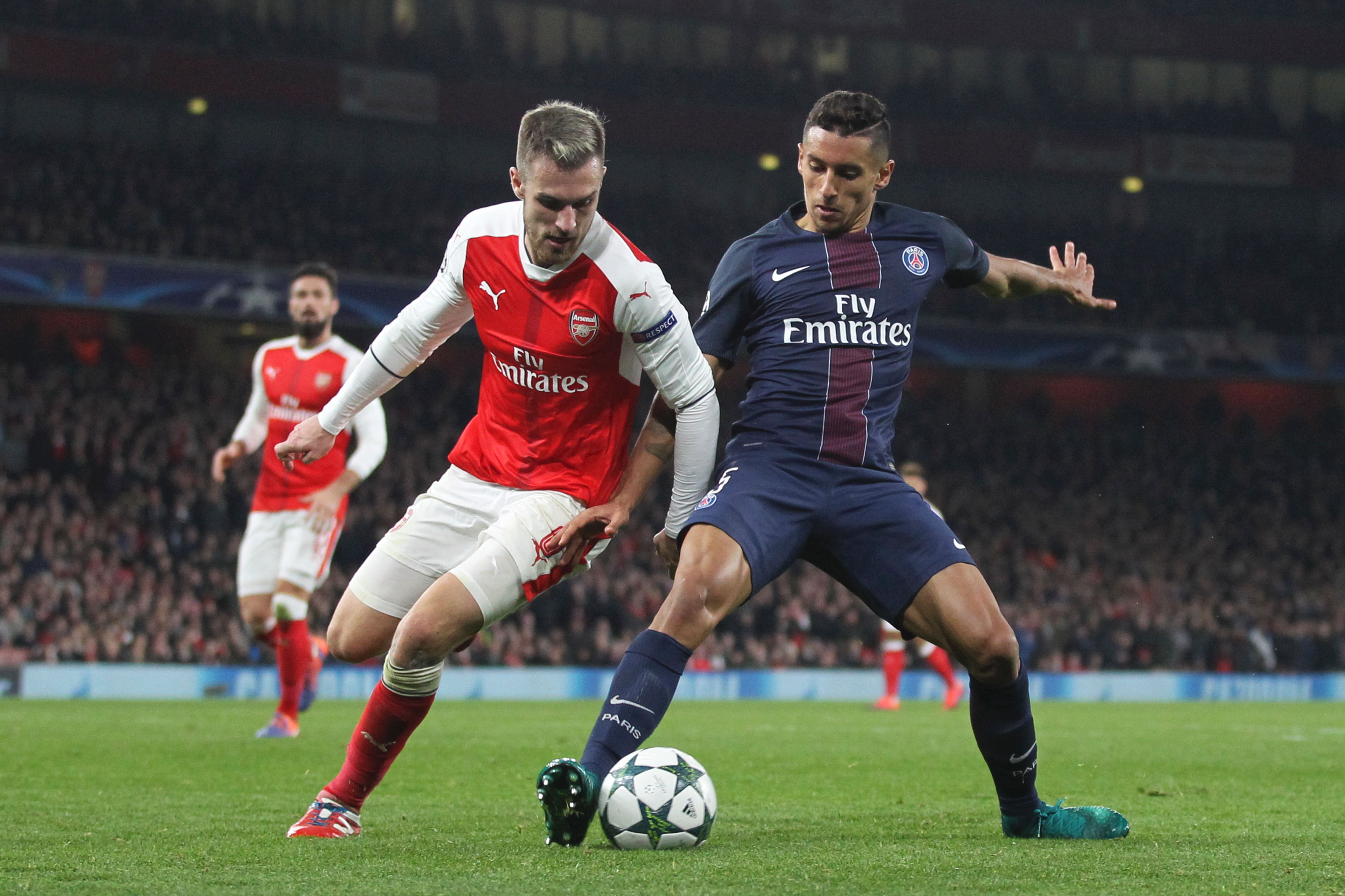 Arsenal's Welsh midfielder Aaron Ramsey (L) challenges Paris Saint-Germain's Brazilian defender Marquinhos (R) during the UEFA Champions League group A football match between Arsenal and Paris Saint-Germain at the Emirates Stadium in London on November 23, 2016.  / AFP / IKIMAGES / Ian KINGTON        (Photo credit should read IAN KINGTON/AFP/Getty Images)