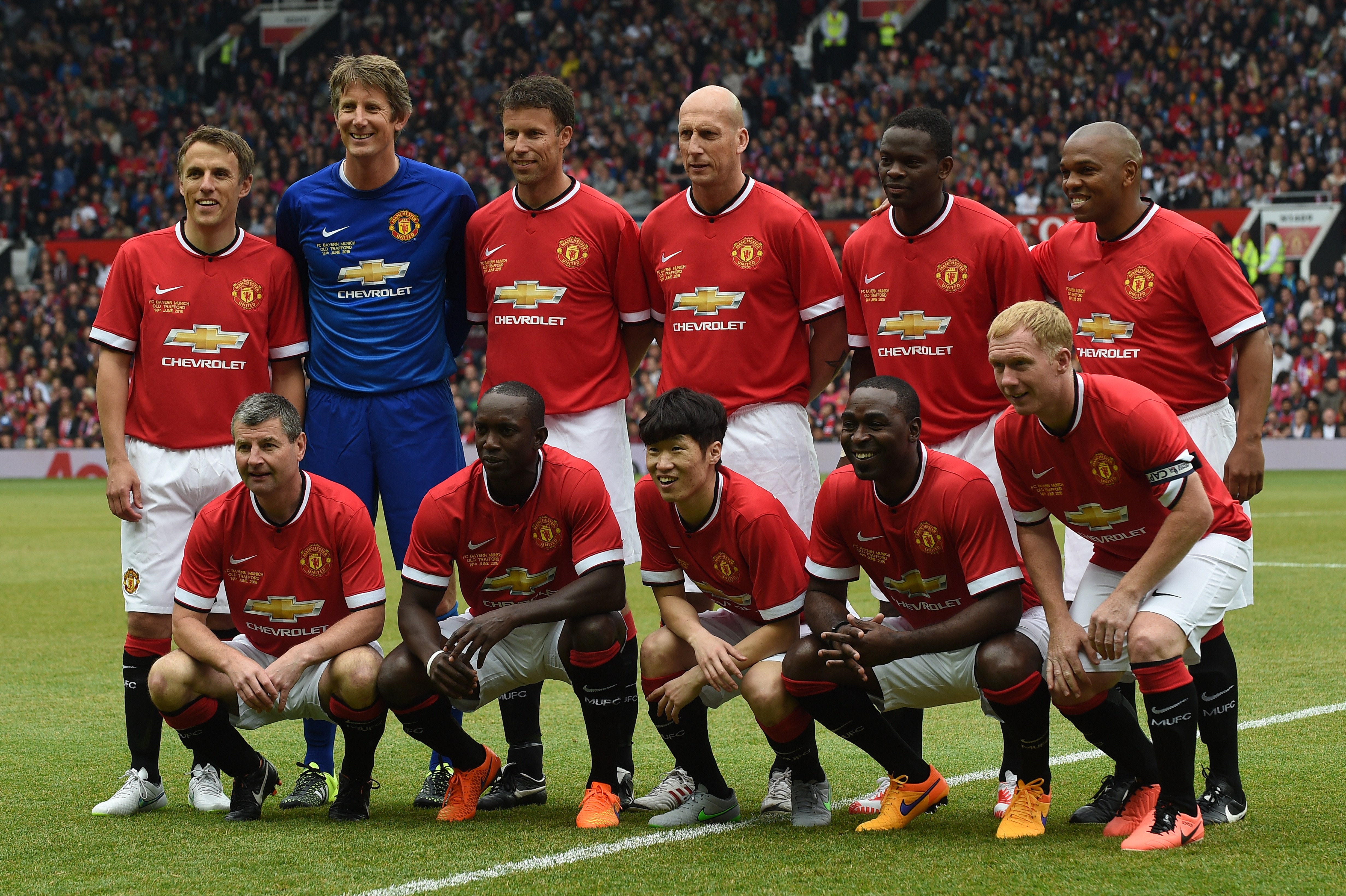 Manchester Utd legends (top L-R) Phil Neville, Edwin van der Sar, Ronny Johnsen, Jaap Stam, Louis Saha, Quinton Fortune (bottom L-R) Denis Irwin, Dwight Yorke, Park Ji-Sung, Andy Cole and Paul Scholes pose for a team photograph at the start of the friendly football match between Manchester United's Legends and Bayern Munich All Stars at Old Trafford in Manchester, northwest England, on June 14, 2015. The charity friendly football match reuniting former Manchester United stars with legends from Bayern Munich was played in aid of the Manchester United Foundation. AFP PHOTO / PAUL ELLIS        (Photo credit should read PAUL ELLIS/AFP/Getty Images)