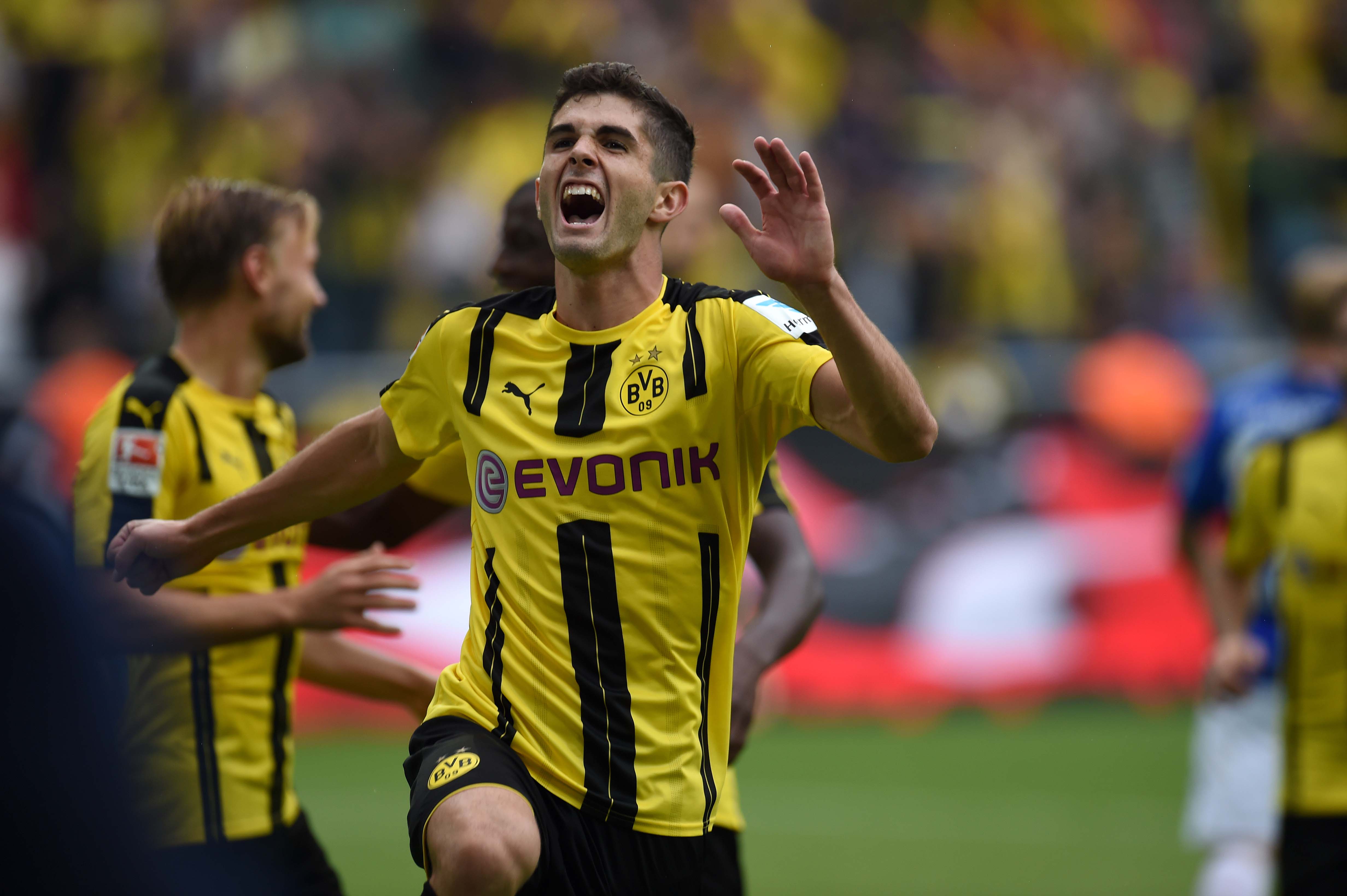 Dortmund's US midfielder Christian Pulisic celebrates during the German first division Bundesliga football match of Borussia Dortmund vs SV Darmstadt 98 in Dortmund, western Germany, on September 17, 2016. / AFP / PATRIK STOLLARZ / RESTRICTIONS: DURING MATCH TIME: DFL RULES TO LIMIT THE ONLINE USAGE TO 15 PICTURES PER MATCH AND FORBID IMAGE SEQUENCES TO SIMULATE VIDEO. == RESTRICTED TO EDITORIAL USE == FOR FURTHER QUERIES PLEASE CONTACT DFL DIRECTLY AT + 49 69 650050
        (Photo credit should read PATRIK STOLLARZ/AFP/Getty Images)