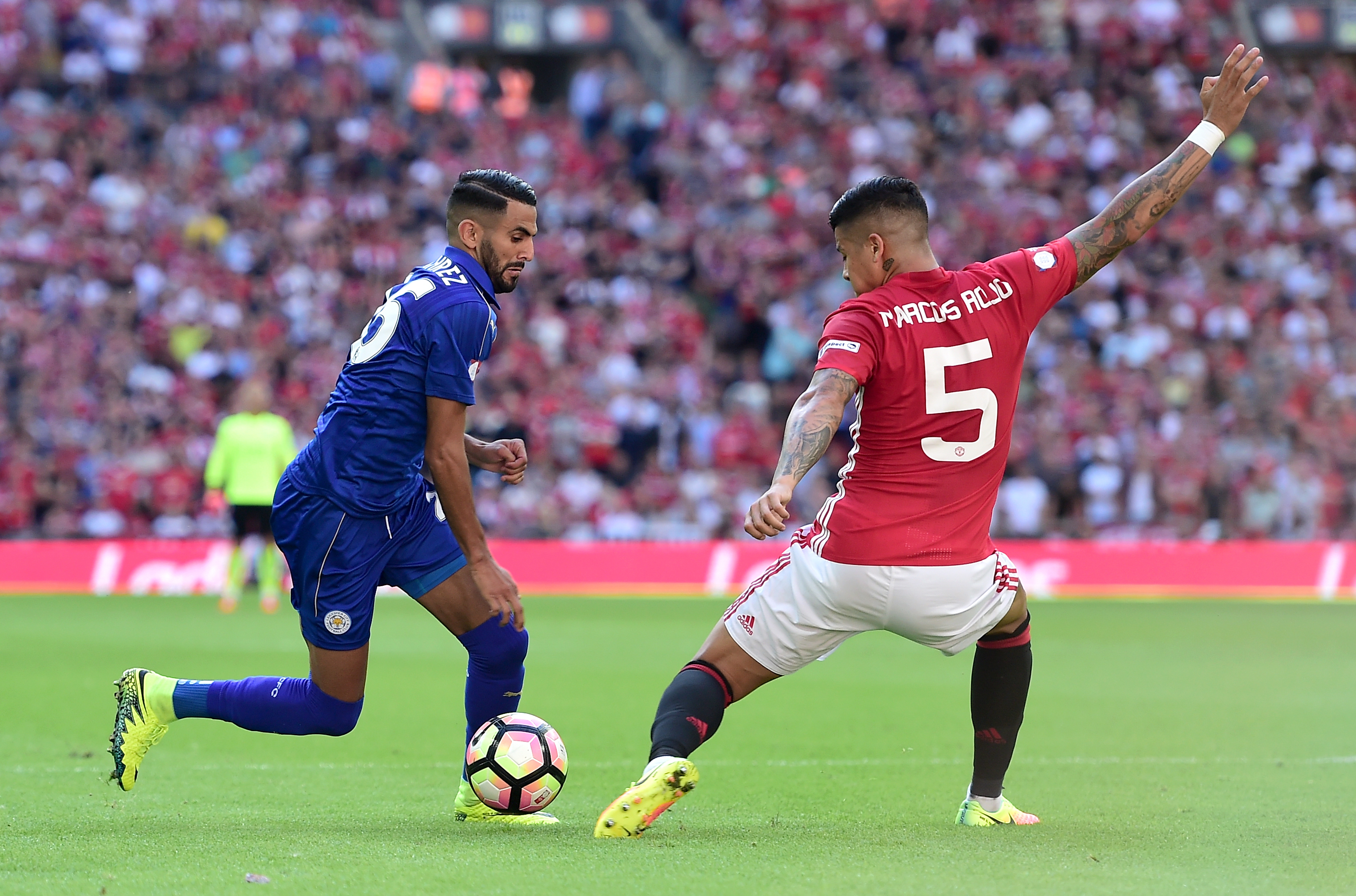 LONDON, ENGLAND - AUGUST 07: Riyad Mahrez of Leicester City takes the ball past Marcos Rojo of Manchester United during The FA Community Shield match between Leicester City and Manchester United at Wembley Stadium on August 7, 2016 in London, England.  (Photo by Alex Broadway/Getty Images)