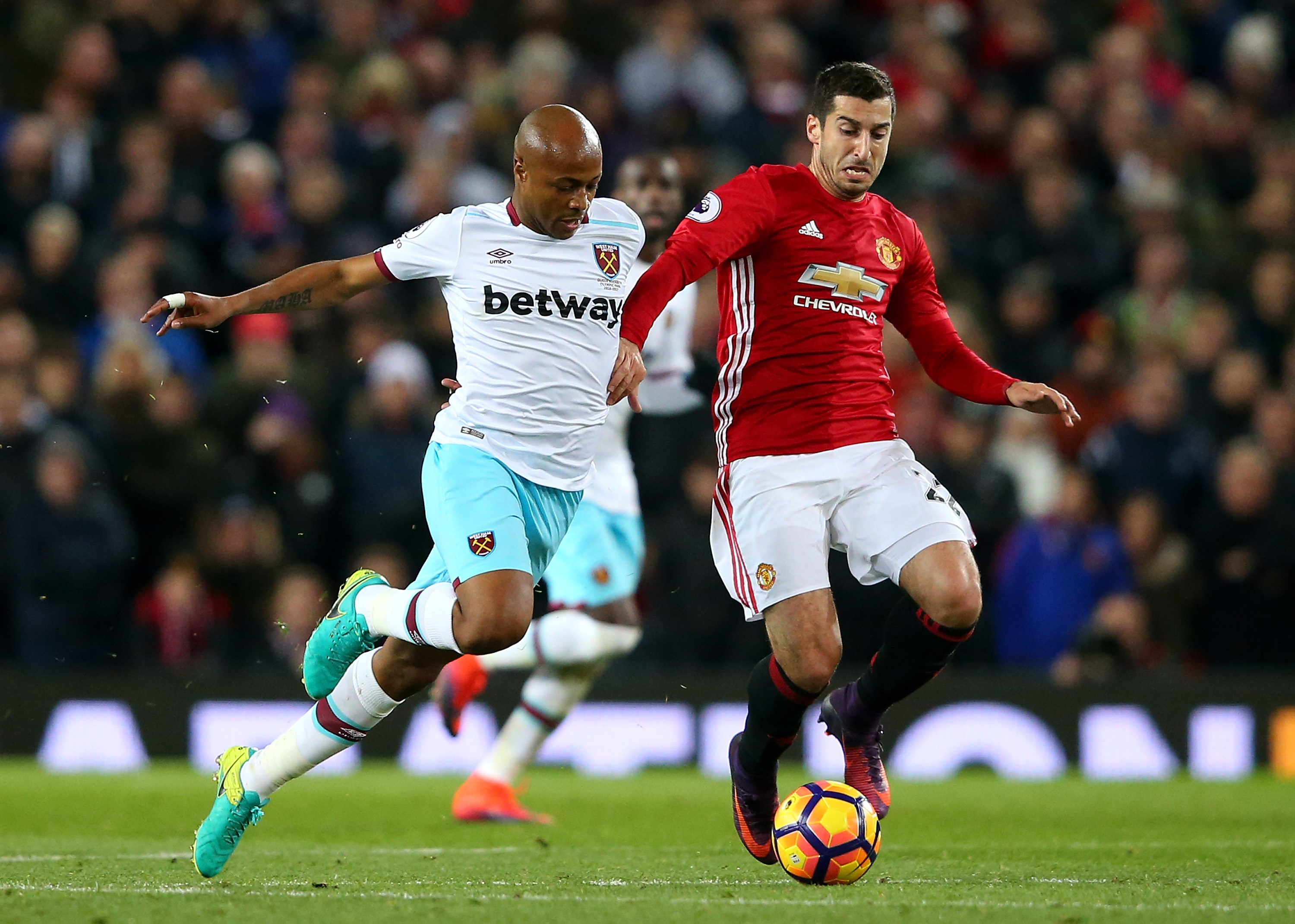 MANCHESTER, ENGLAND - NOVEMBER 27: Andre Ayew of West Ham United (L) and Henrikh Mkhitaryan of Manchester United (R) battle for possession during the Premier League match between Manchester United and West Ham United at Old Trafford on November 27, 2016 in Manchester, England.  (Photo by Alex Livesey/Getty Images)