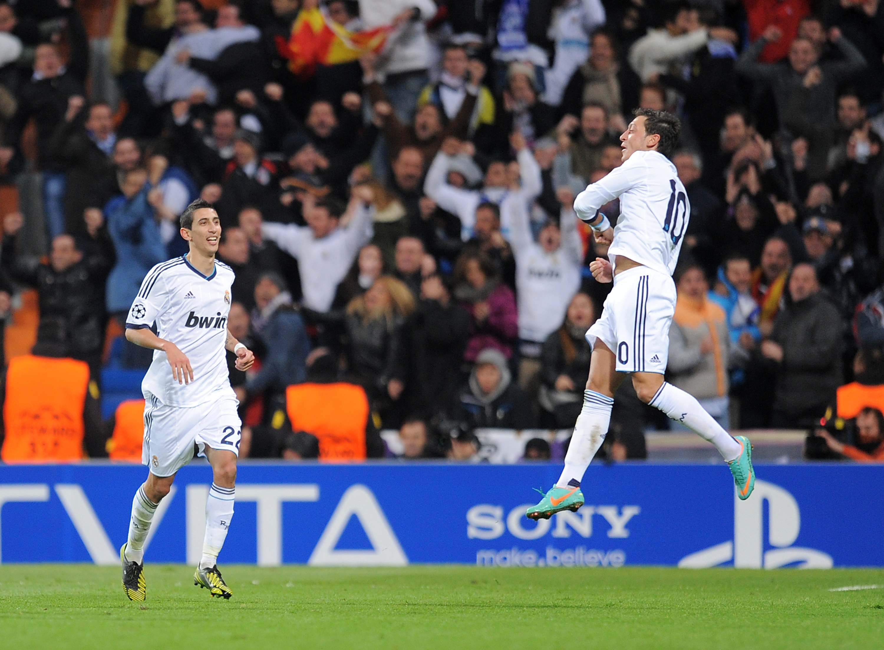 MADRID, SPAIN - NOVEMBER 06:  Mesut Ozil (R) of Real Madrid celebrates with Angel Di Maria after scoring their goal during the UEFA Champions League Group D match between Real Madrid and Borussia Dortmund at Estadio Santiago Bernabeu on November 6, 2012 in Madrid, Spain.  (Photo by Denis Doyle/Getty Images)