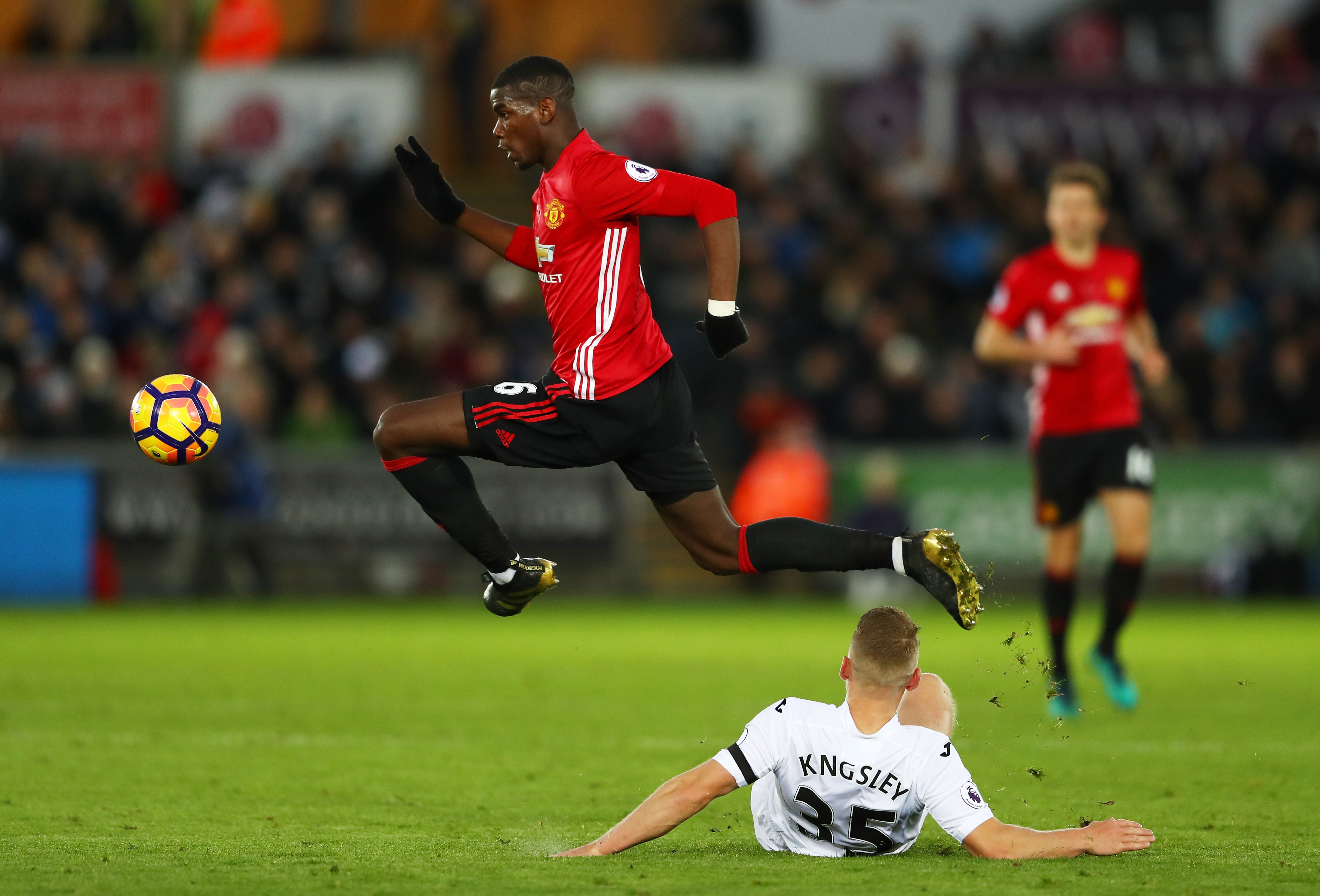 SWANSEA, WALES - NOVEMBER 06: Stephen Kingsley of Swansea City attempts to tackle Paul Pogba of Manchester United during the Premier League match between Swansea City and Manchester United at Liberty Stadium on November 6, 2016 in Swansea, Wales.  (Photo by Michael Steele/Getty Images)