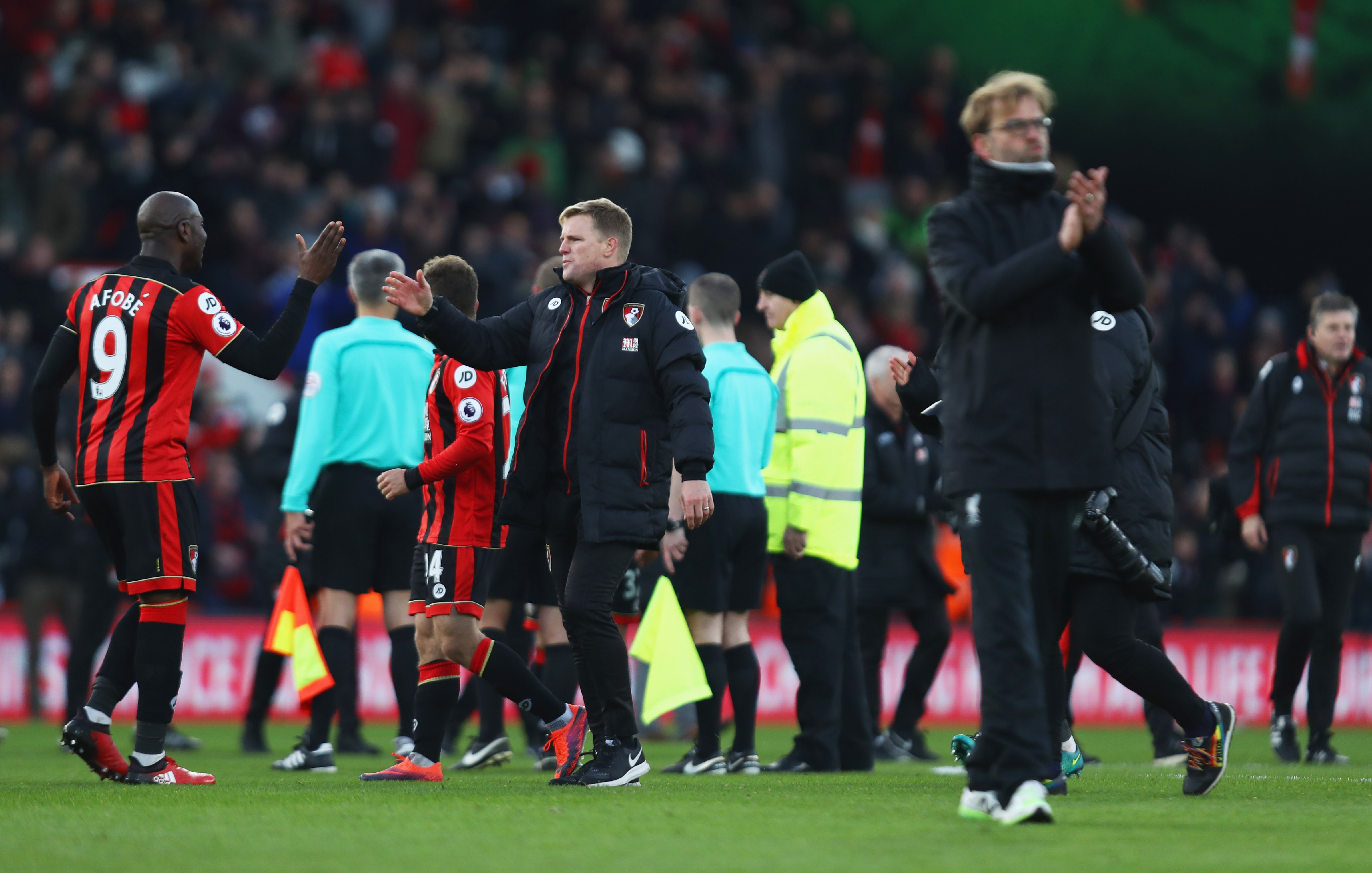 BOURNEMOUTH, ENGLAND - DECEMBER 04:  Eddie Howe manager of AFC Bournemouth celebrates victory with Benik Afobe as Jurgen Klopp manager of Liverpool looks dejected after the Premier League match between AFC Bournemouth and Liverpool at Vitality Stadium on December 4, 2016 in Bournemouth, England.  (Photo by Bryn Lennon/Getty Images)