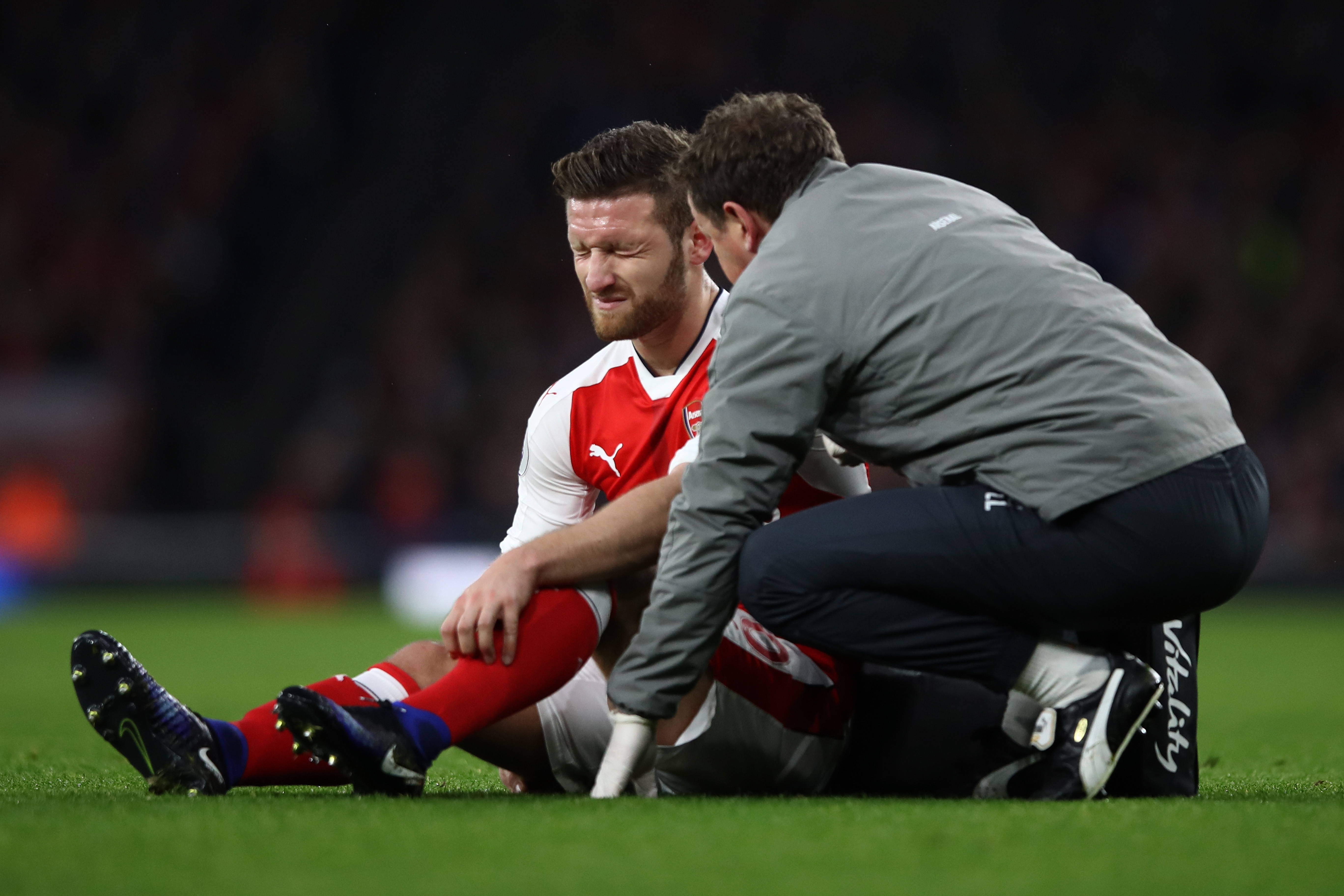 LONDON, ENGLAND - DECEMBER 10: Shkodran Mustafi of Arsenal speaks to a member of the Arsenal medical team after going down injured during the Premier League match between Arsenal and Stoke City at the Emirates Stadium on December 10, 2016 in London, England.  (Photo by Julian Finney/Getty Images)