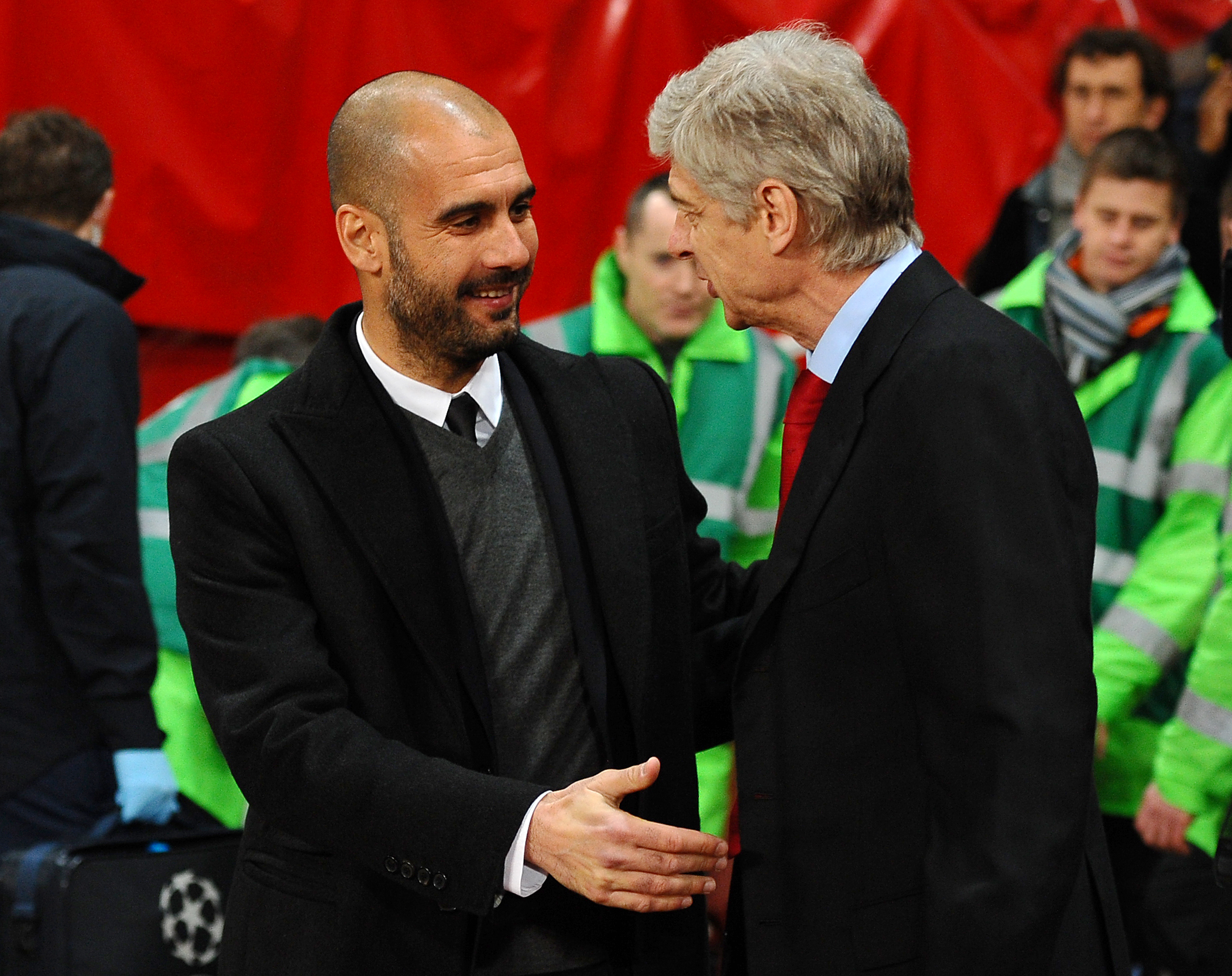 Arsenal's French coach Ars?ne Wenger (R) welcomes to Barcelona's coach Pep Guardiola (L) before their Champions League round of 16, 1st leg football match Arsenal vs FC Barcelona on February 16, 2011 at the Emirates Stadium in London. AFP PHOTO/LLUIS GENE. (Photo credit should read LLUIS GENE/AFP/Getty Images)