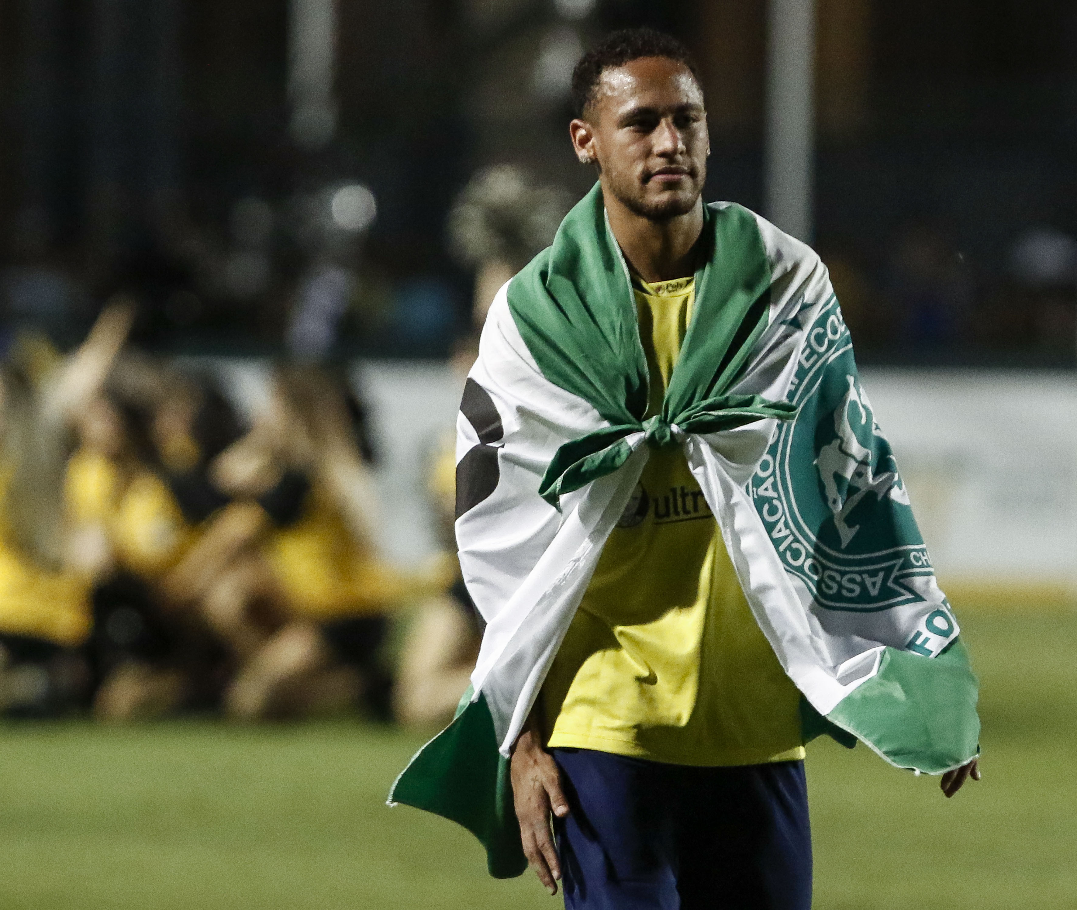 Brazil's Neymar of Spanish team Barcelona uses a flag in tribute to the victims of the November 28, 2016 Colombia plane crash that killed nearly the entire Brazilian Chapecoense football team during the charity football match Ousadia vs Pedalada at Pacaembu stadium in Sao Paulo, on December 22, 2016.
Donations will go to the Neymar Jr. Project Institute in Praia Grande, São Paulo. / AFP / Miguel SCHINCARIOL        (Photo credit should read MIGUEL SCHINCARIOL/AFP/Getty Images)