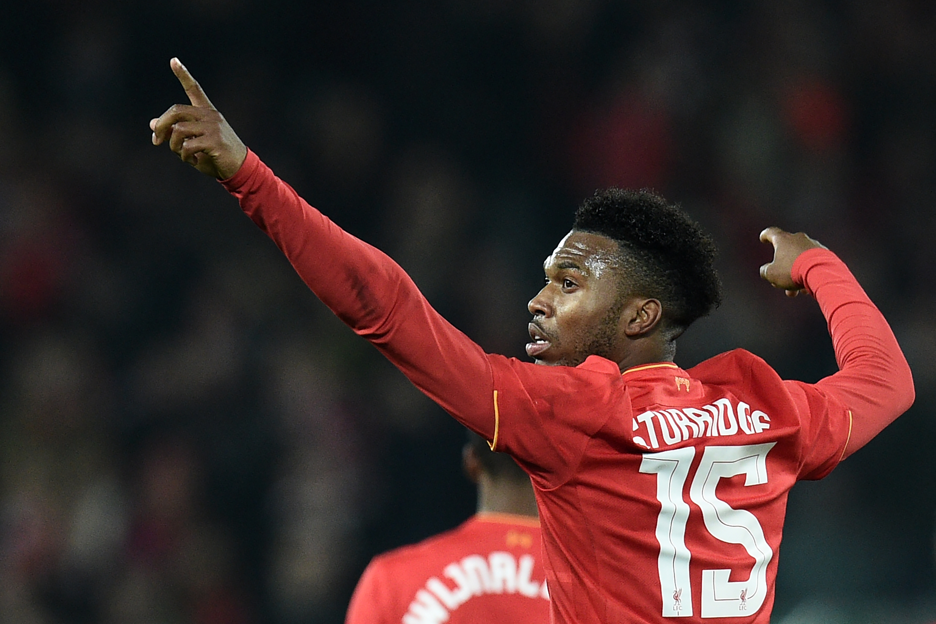 Liverpool's English striker Daniel Sturridge celebrates after scoring their second goal during the EFL (English Football League) Cup fourth round match between Liverpool and Tottenham Hotspur at Anfield in Liverpool north west England on October 25, 2016. / AFP / Oli SCARFF / RESTRICTED TO EDITORIAL USE. No use with unauthorized audio, video, data, fixture lists, club/league logos or 'live' services. Online in-match use limited to 75 images, no video emulation. No use in betting, games or single club/league/player publications.  /         (Photo credit should read OLI SCARFF/AFP/Getty Images)