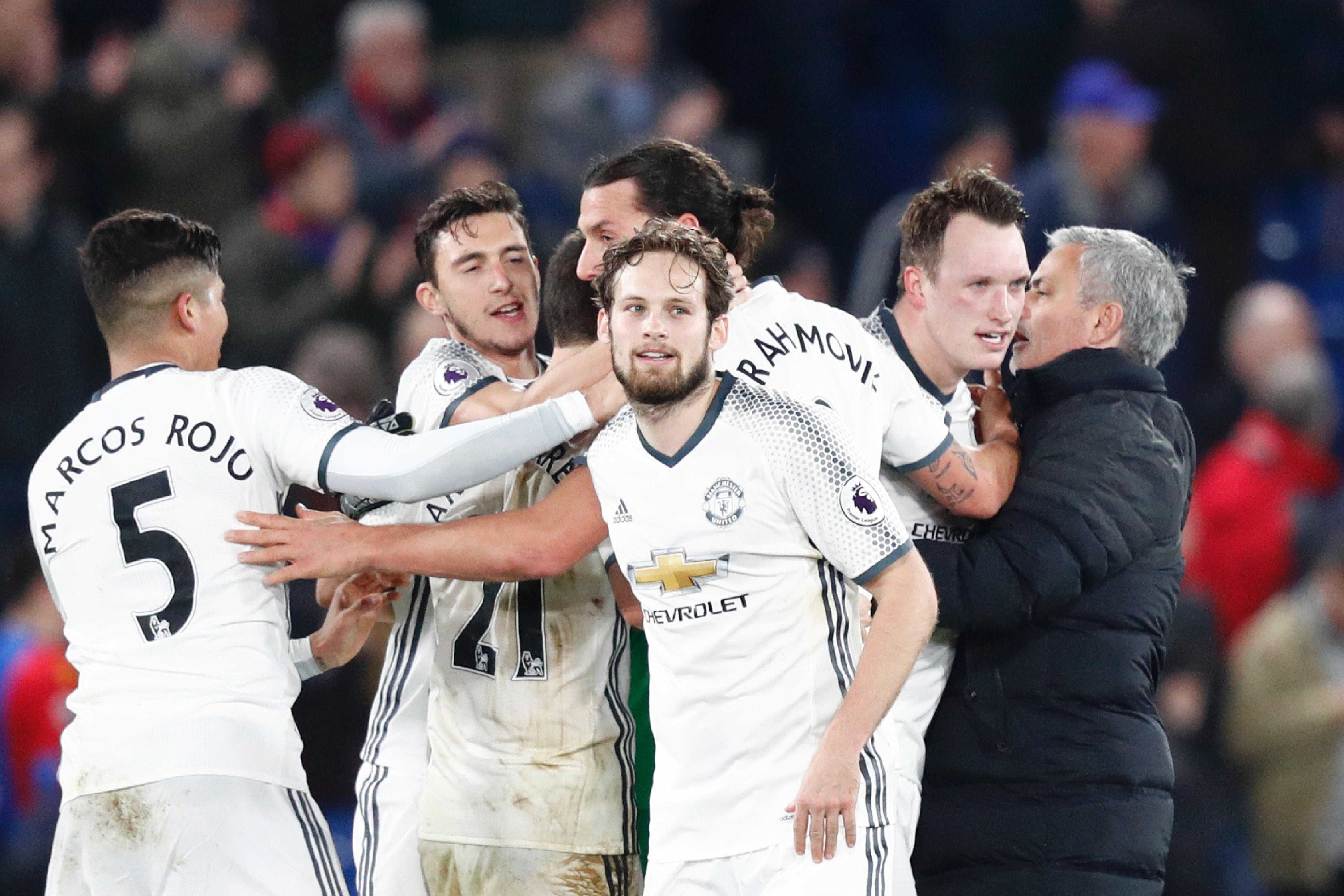 Manchester United's Portuguese manager Jose Mourinho (R) congratulates his players following the English Premier League football match between Crystal Palace and Manchester United at Selhurst Park in south London on December 14, 2016. / AFP / Adrian DENNIS / RESTRICTED TO EDITORIAL USE. No use with unauthorized audio, video, data, fixture lists, club/league logos or 'live' services. Online in-match use limited to 75 images, no video emulation. No use in betting, games or single club/league/player publications.  /         (Photo credit should read ADRIAN DENNIS/AFP/Getty Images)