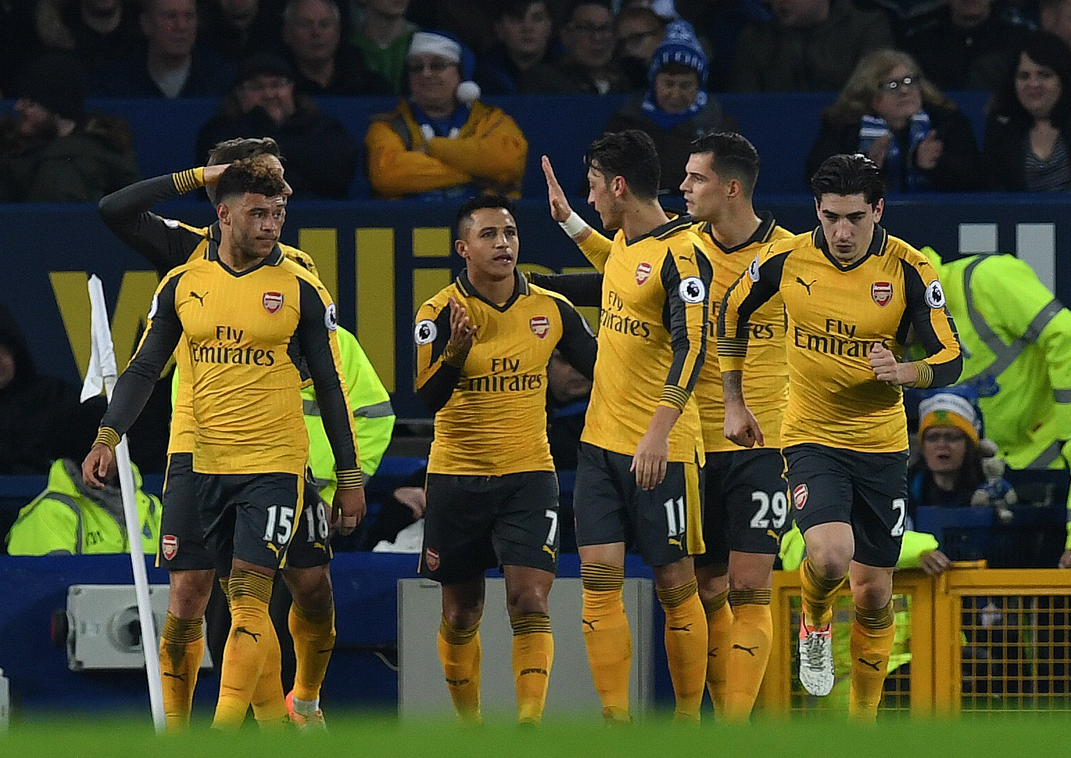 Arsenal's Chilean striker Alexis Sanchez (3L) celebrates scoring his team's first goal during the English Premier League football match between Everton and Arsenal at Goodison Park in Liverpool, north west England on December 13, 2016. / AFP / Paul ELLIS / RESTRICTED TO EDITORIAL USE. No use with unauthorized audio, video, data, fixture lists, club/league logos or 'live' services. Online in-match use limited to 75 images, no video emulation. No use in betting, games or single club/league/player publications.  /         (Photo credit should read PAUL ELLIS/AFP/Getty Images)