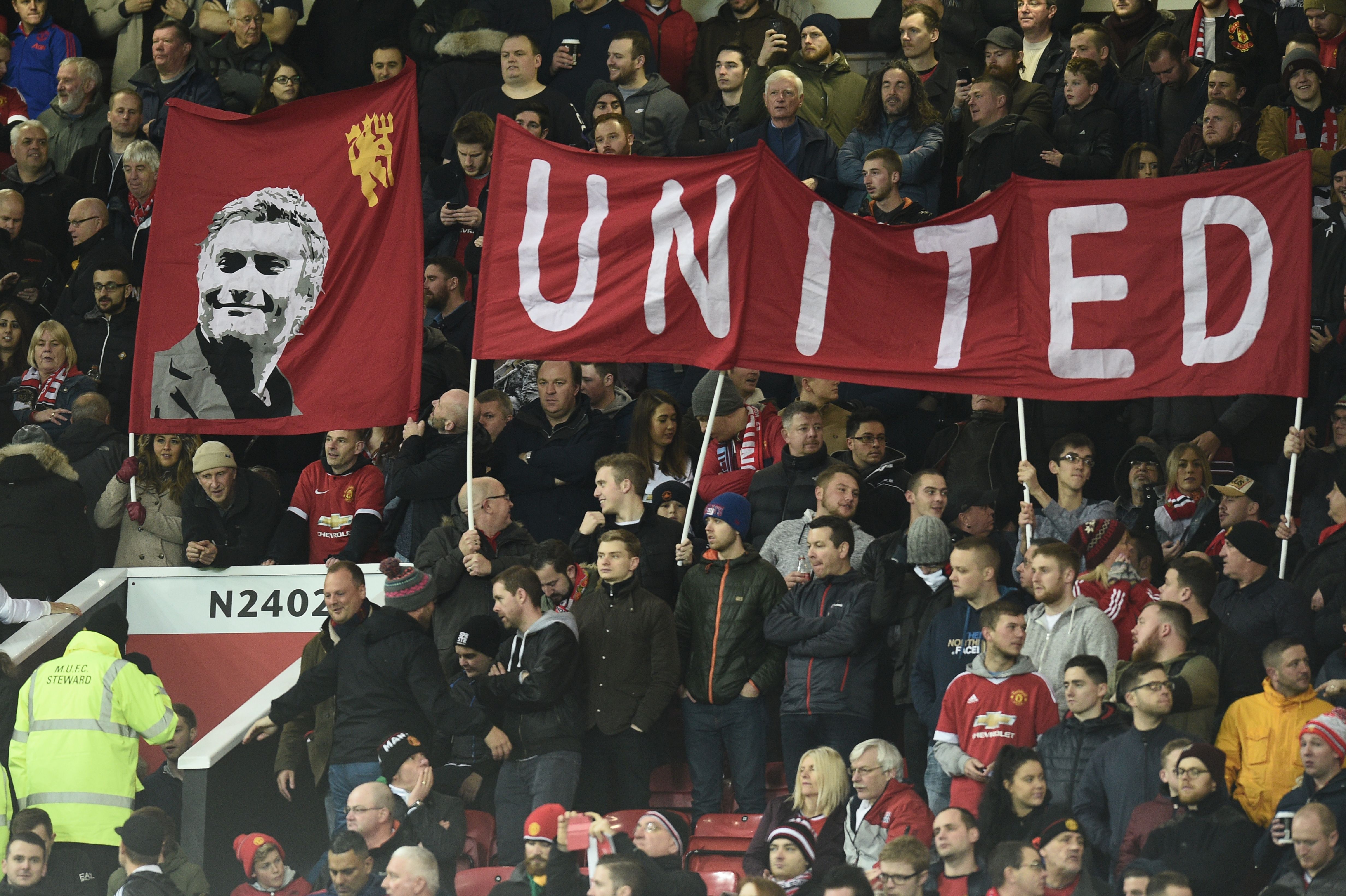 Manchester United banners are seen in the crowd during the English Premier League football match between Manchester United and West Ham United at Old Trafford in Manchester, north west England, on November 27, 2016. / AFP / Oli SCARFF / RESTRICTED TO EDITORIAL USE. No use with unauthorized audio, video, data, fixture lists, club/league logos or 'live' services. Online in-match use limited to 75 images, no video emulation. No use in betting, games or single club/league/player publications.  /         (Photo credit should read OLI SCARFF/AFP/Getty Images)