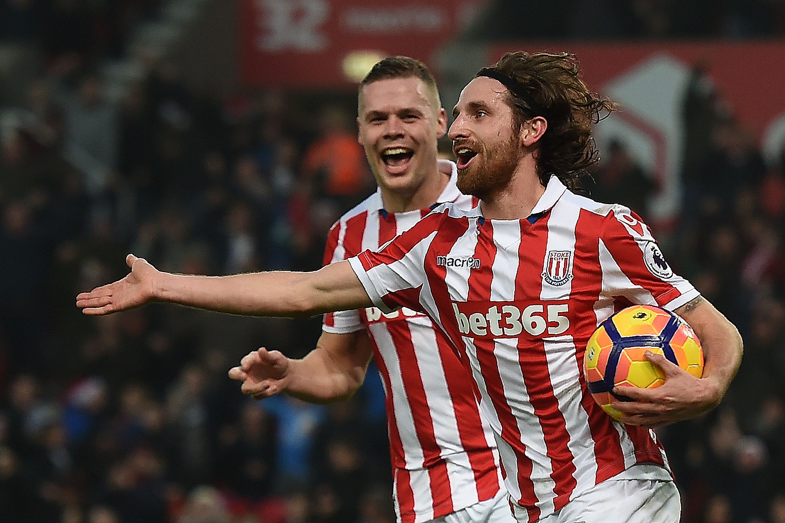 Stoke City's Welsh midfielder Joe Allen (R) celebrates scoring his team's second goal during the English Premier League football match between Stoke City and Leicester City at the Bet365 Stadium in Stoke-on-Trent, central England on December 17, 2016. / AFP / Paul ELLIS / RESTRICTED TO EDITORIAL USE. No use with unauthorized audio, video, data, fixture lists, club/league logos or 'live' services. Online in-match use limited to 75 images, no video emulation. No use in betting, games or single club/league/player publications.  /         (Photo credit should read PAUL ELLIS/AFP/Getty Images)