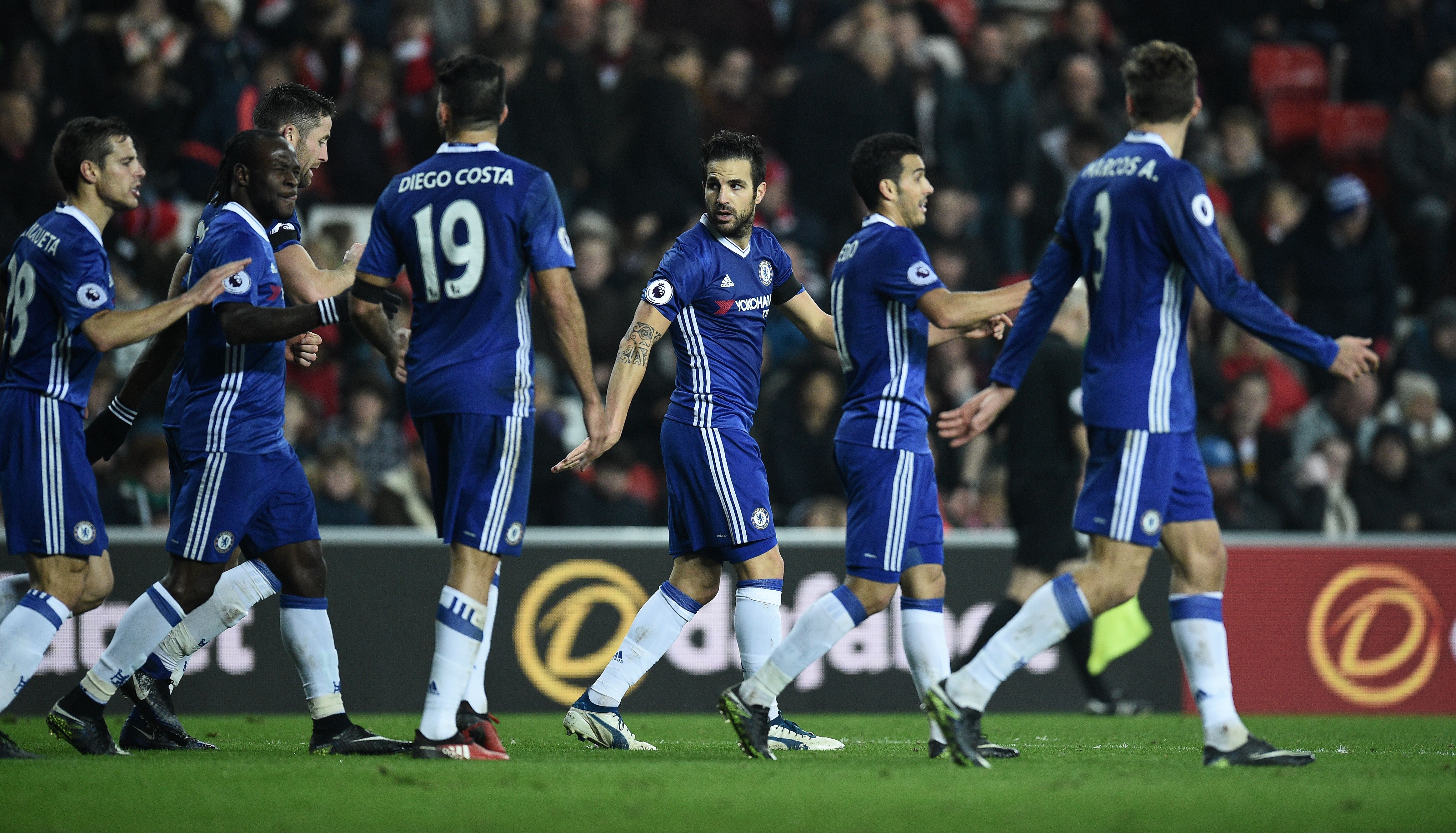 Chelsea's Spanish midfielder Cesc Fabrega (C) celebrates scoring his team's first goal during the English Premier League football match between Sunderland and Chelsea at the Stadium of Light in Sunderland, north-east England on December 14, 2016. / AFP / Oli SCARFF / RESTRICTED TO EDITORIAL USE. No use with unauthorized audio, video, data, fixture lists, club/league logos or 'live' services. Online in-match use limited to 75 images, no video emulation. No use in betting, games or single club/league/player publications.  /         (Photo credit should read OLI SCARFF/AFP/Getty Images)